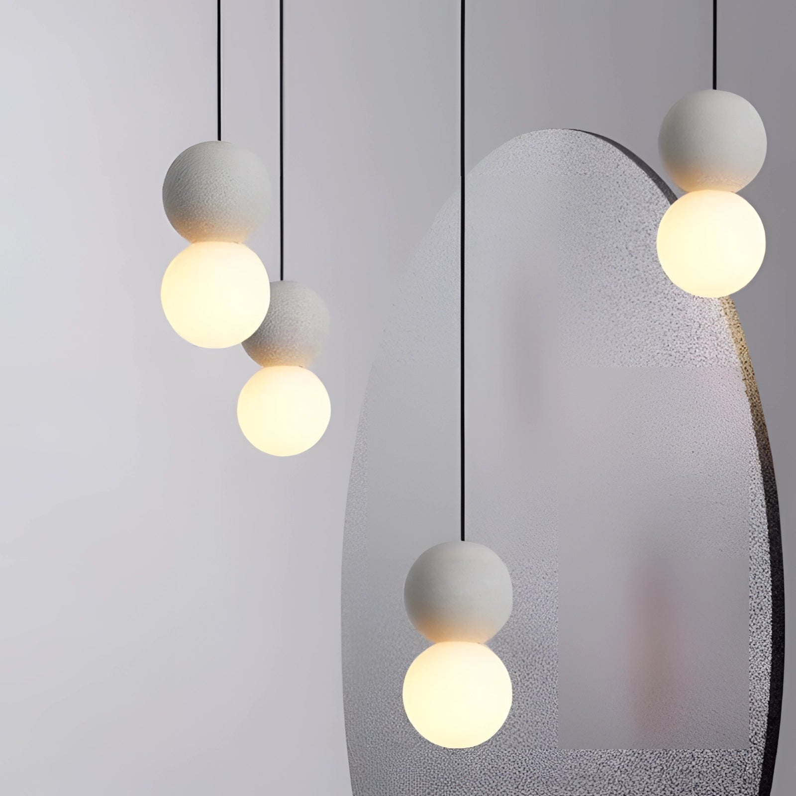 Modern minimalist LED pendant light with a black and gray spherical design, suspended from the ceiling as a stylish and functional fixture, illuminating the interior space with its sleek and artistic appearance.
