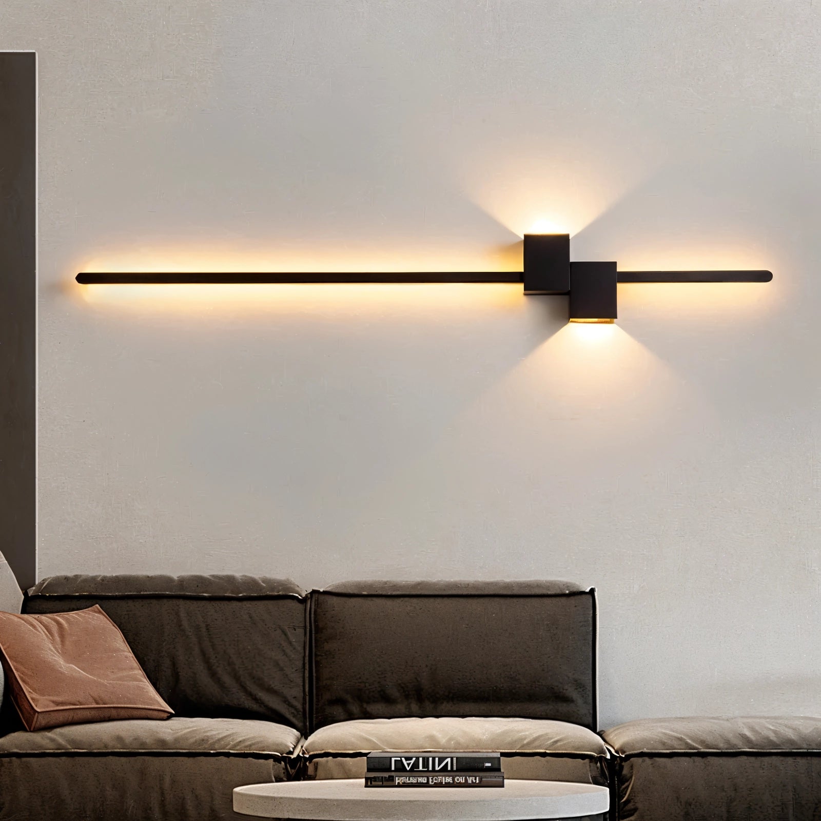 Modern minimalist LED wall light in black, measuring 92cm, installed above a contemporary couch in a stylishly designed bedroom with a focus on comfort, featuring wooden accents and a clean rectangular design.