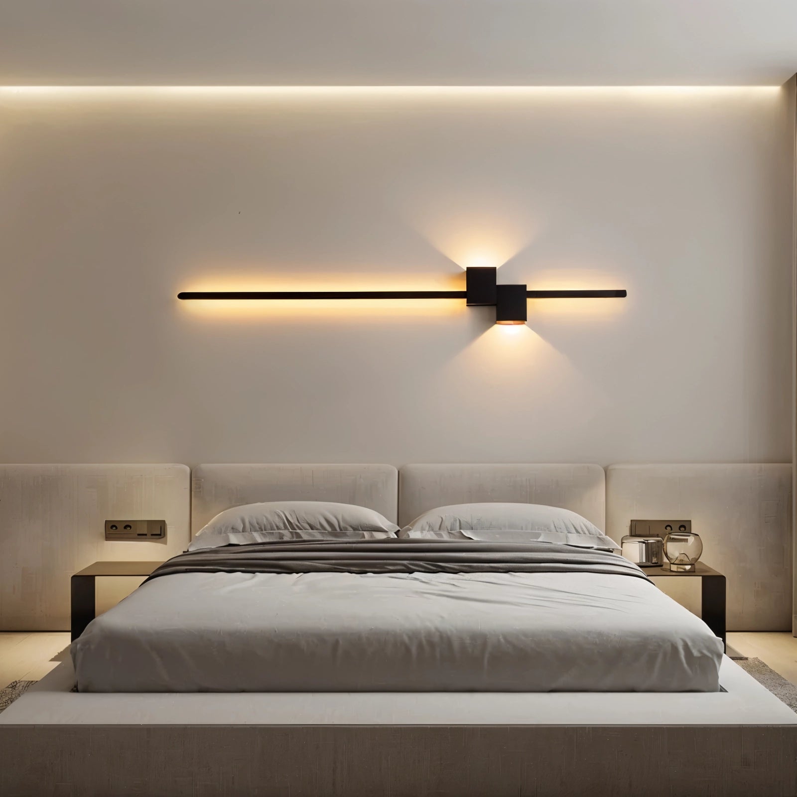 Modern minimalist LED wall light mounted in a contemporary bedroom, featuring a wooden bed frame, grey color scheme, and complementary furniture including cabinetry and a ceiling fan.