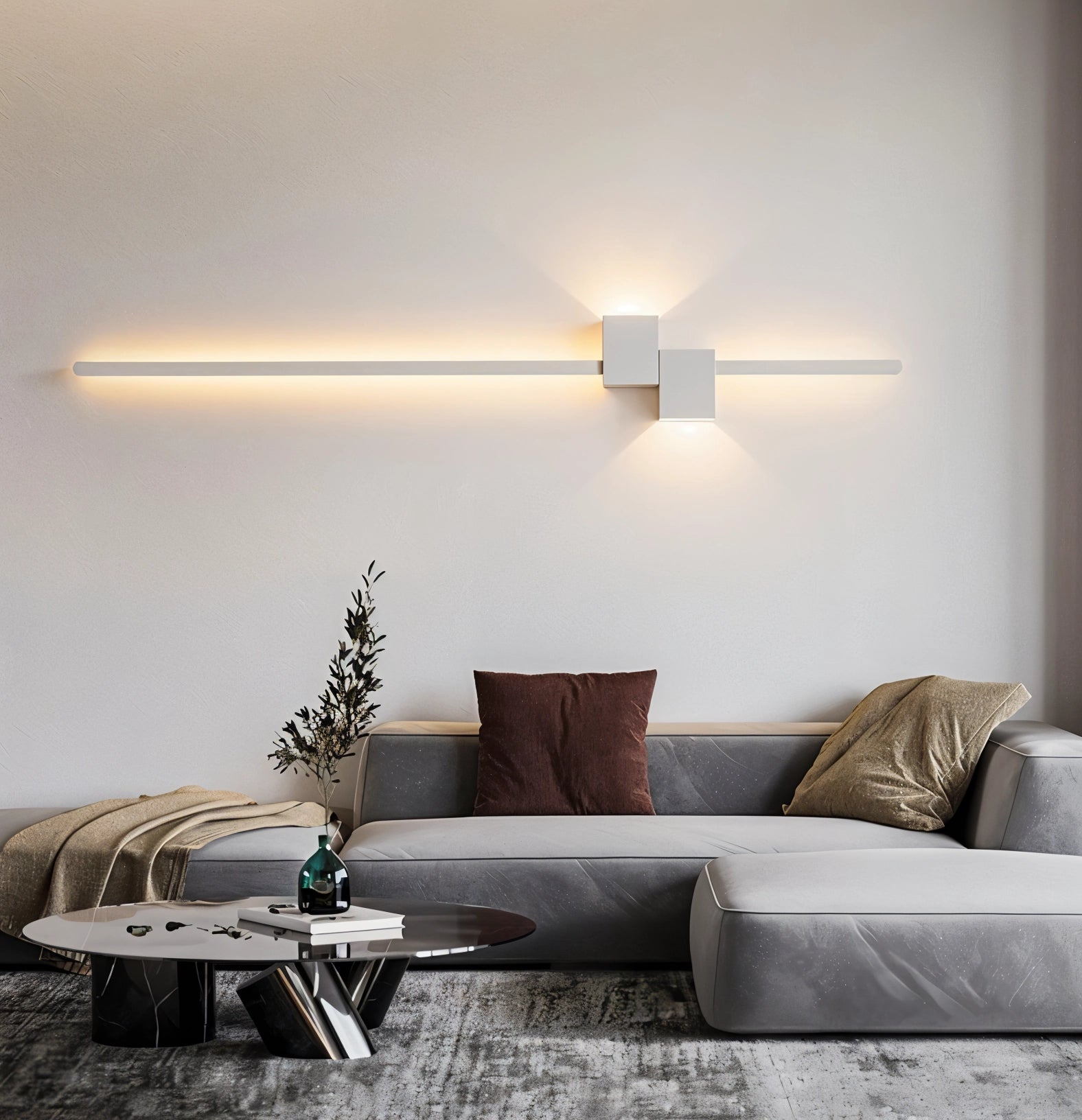 Modern minimalist LED wall light in white, 92cm in length, mounted on a wall above a contemporary-style couch, providing ambient lighting in a stylishly designed bedroom interior.