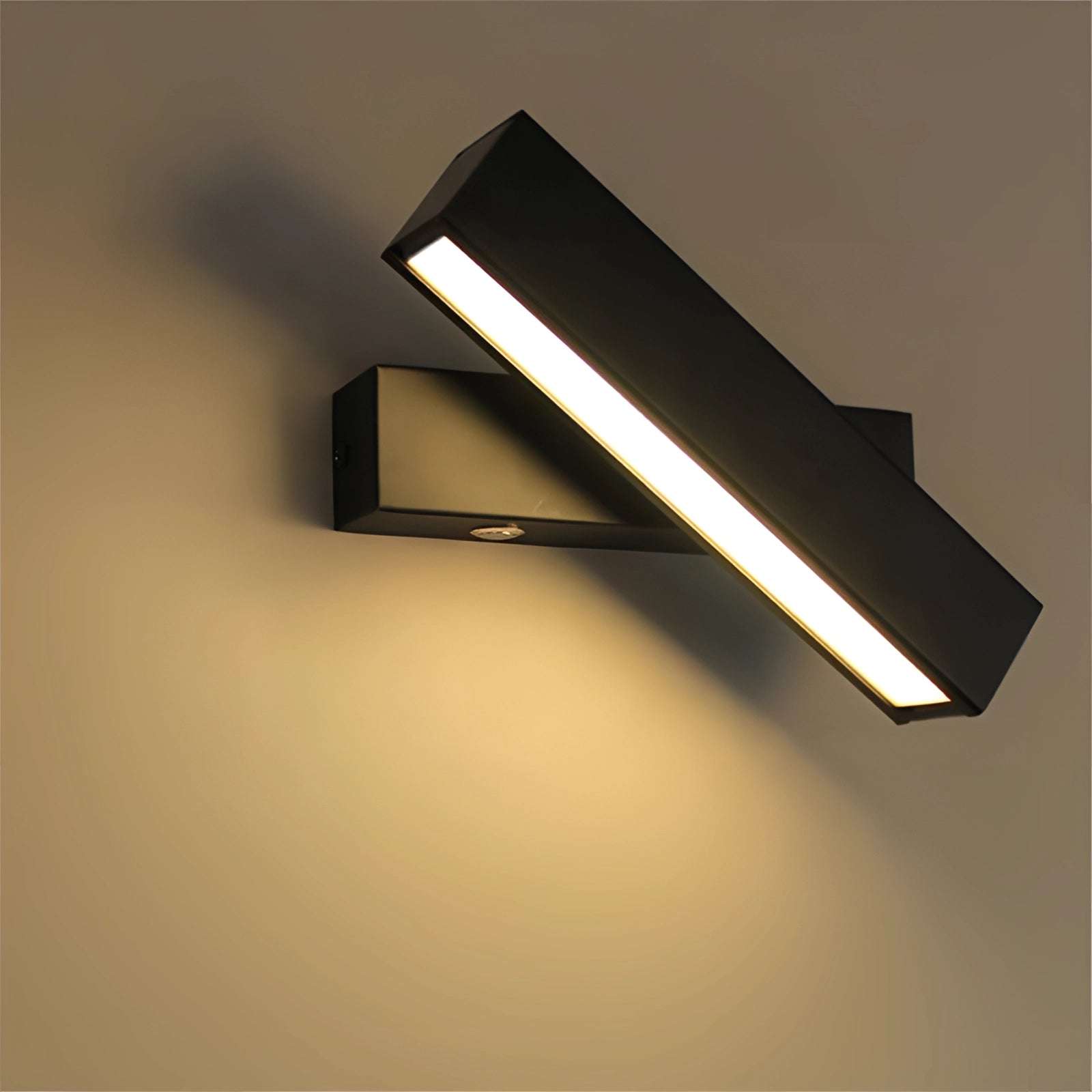 Modern minimalist LED wall sconce with a sleek angular design, featuring a rectangular black metal frame. Emits a cold light, enhancing its contemporary aesthetic.