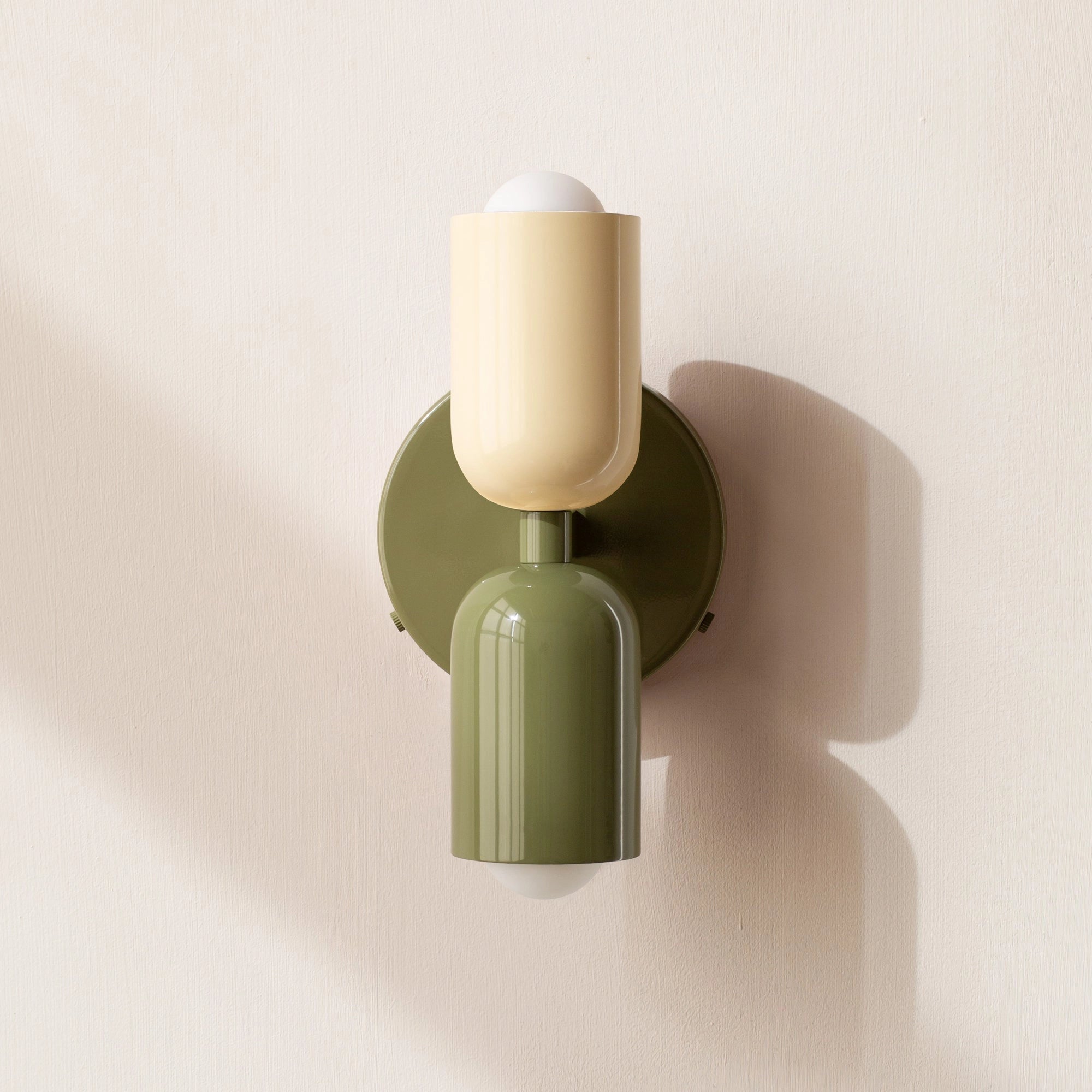 Modern minimalist LED wall sconce with geometric dual head design featuring a white, green, and green color scheme, incorporating wood and metal materials, mounted as a stylish light fixture.