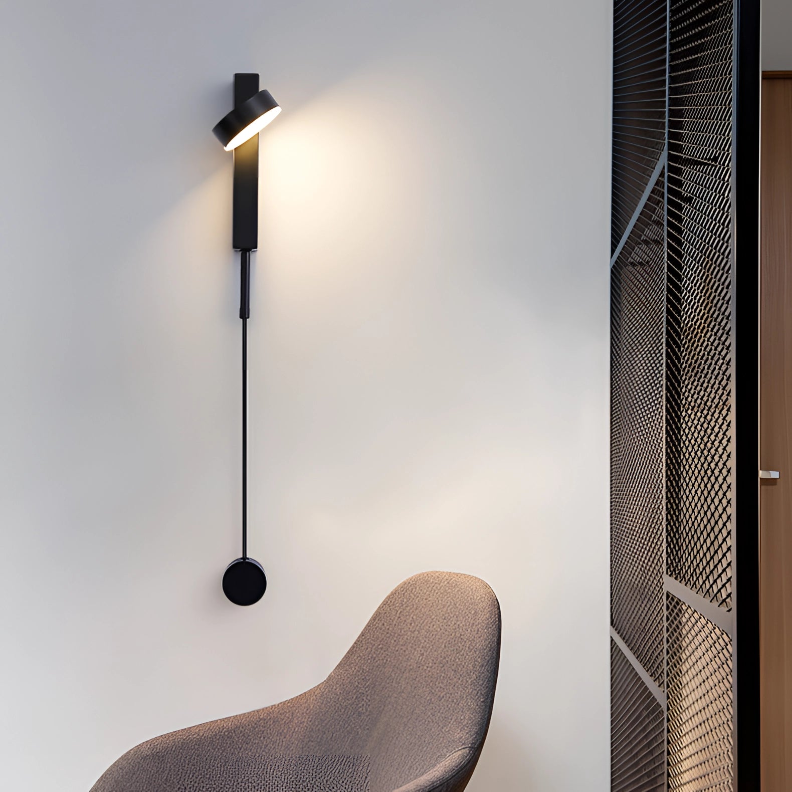 Modern minimalist black LED wall sconce with an adjustable design, installed on a grey wall, emits a bright white light at 5000K.
