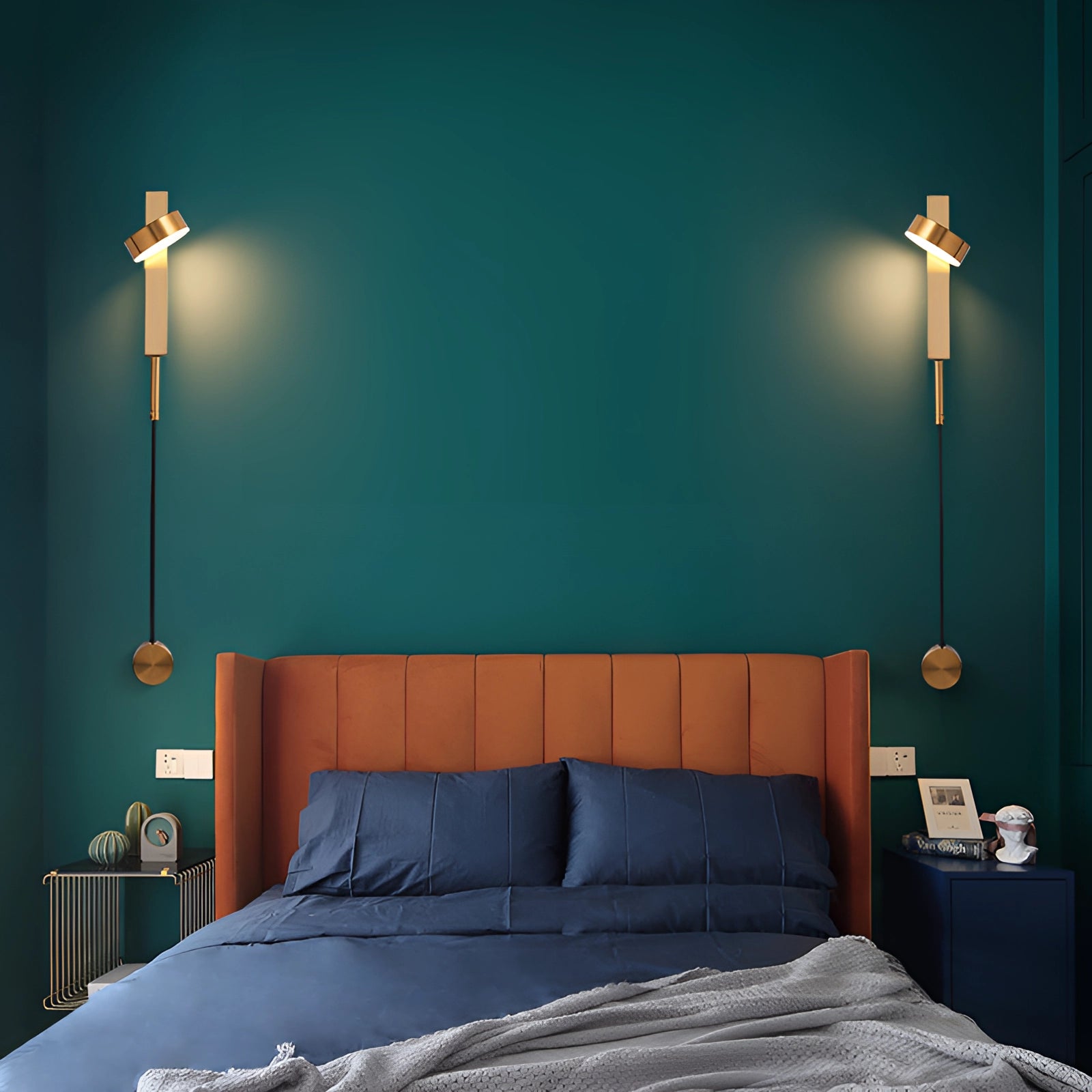 Modern minimalist LED wall sconce with a gold finish, designed for bedrooms, emits white light (5000K) suitable for 220 V-240 V regions like the UK and Australia, shown installed beside a wooden bed frame in a stylish, azure-themed interior.