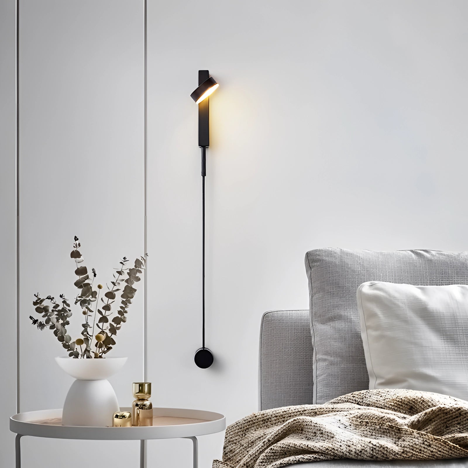 Modern black LED wall sconce with a minimalist design, mounted on a grey wall. The fixture is rectangular in shape, providing warm light (3000K) suitable for bedrooms in the USA and Canada. Ideal for contemporary interior design and enhancing the comfort of living spaces.