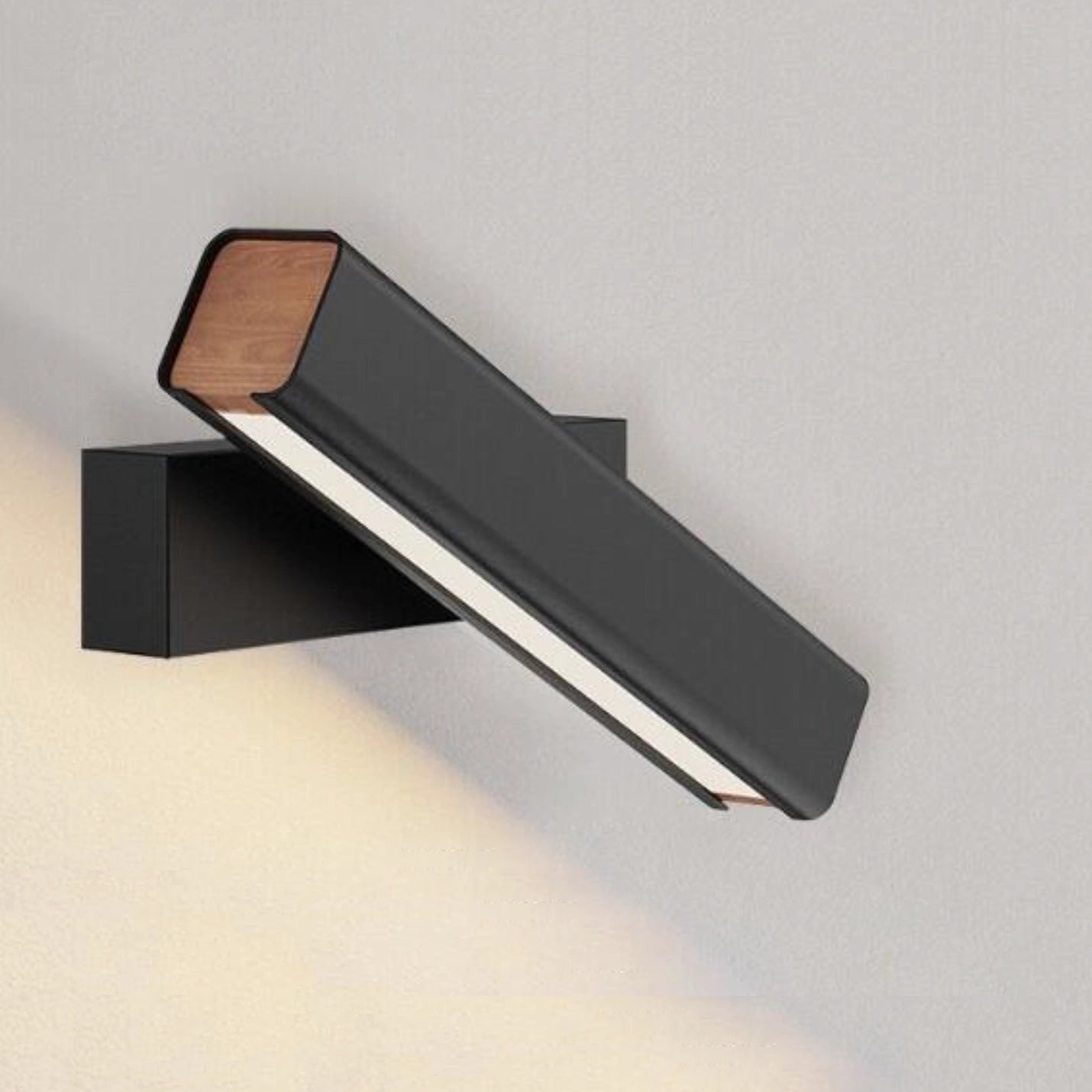 Modern minimalist LED wall sconce with a sleek, angular design crafted from aluminum, featuring a rectangular shape and a smooth, metallic finish.