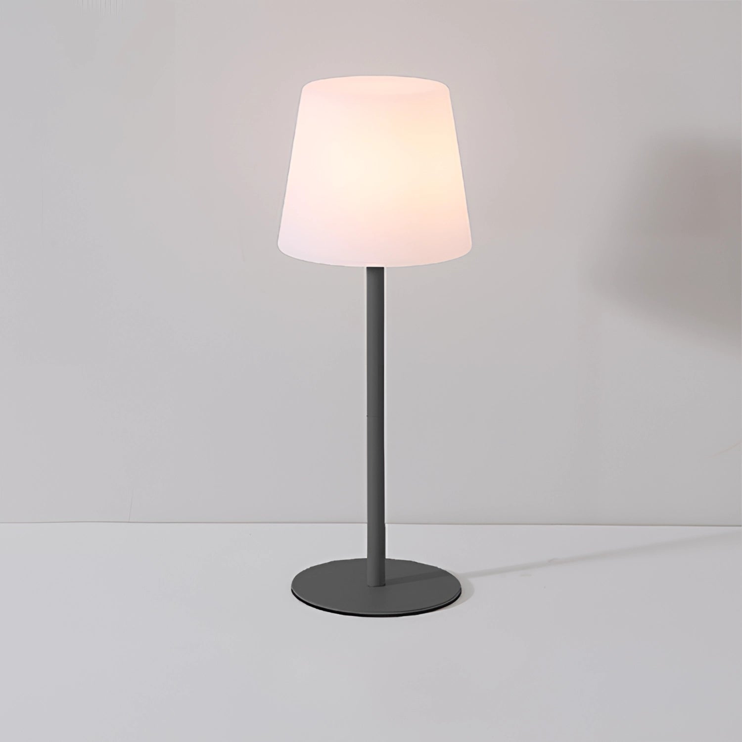 Modern minimalist pastel table lamp with a rectangular wooden base and a soft-hued lampshade, designed for chic living room or bedroom decor.