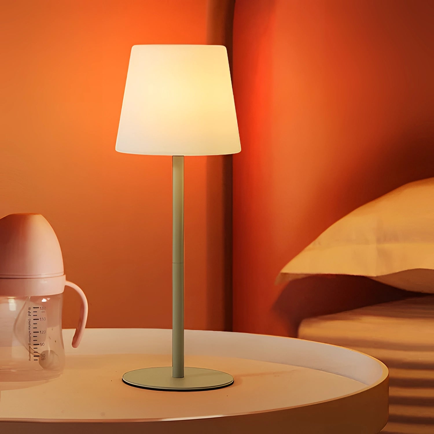Modern minimalist pastel table lamp with a wooden base and a soft, warm orange shade, designed for chic living room or bedroom lighting.