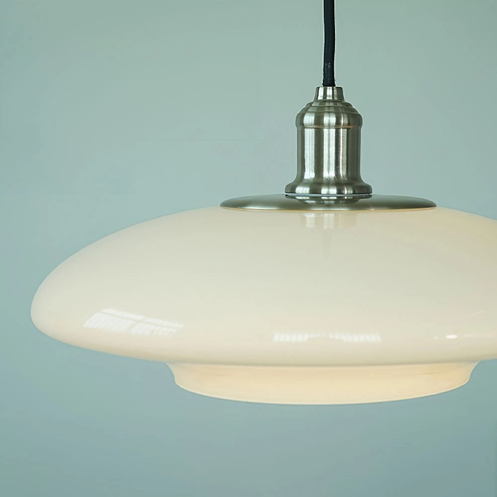 A modern minimalist pendant light featuring an oval-shaped frosted glass shade, suspended from the ceiling with an adjustable height metal fixture.