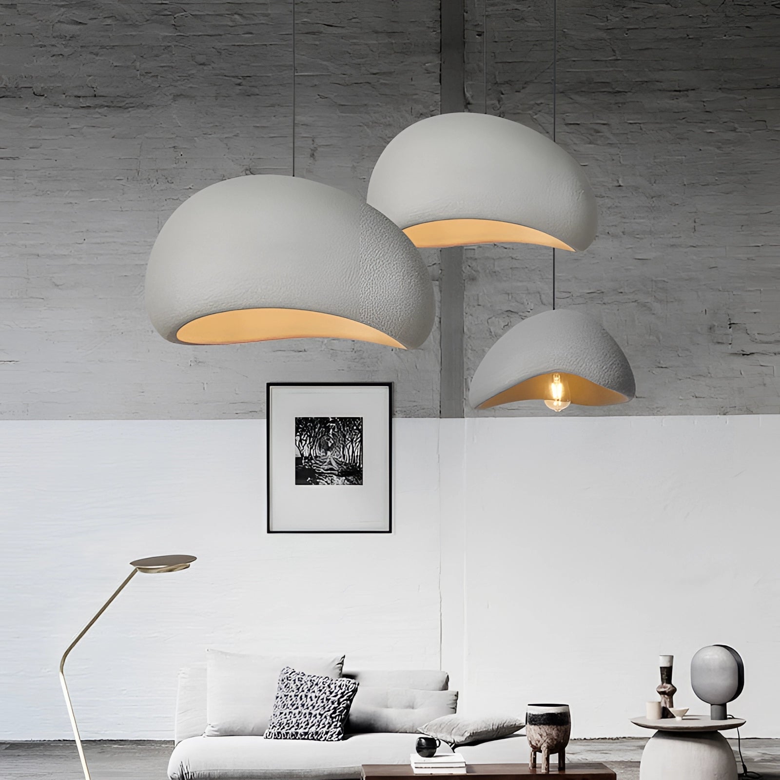 Modern minimalist pendant lights with a Scandinavian design, featuring sleek grey lamps hanging from the ceiling, illuminating a stylish interior space.