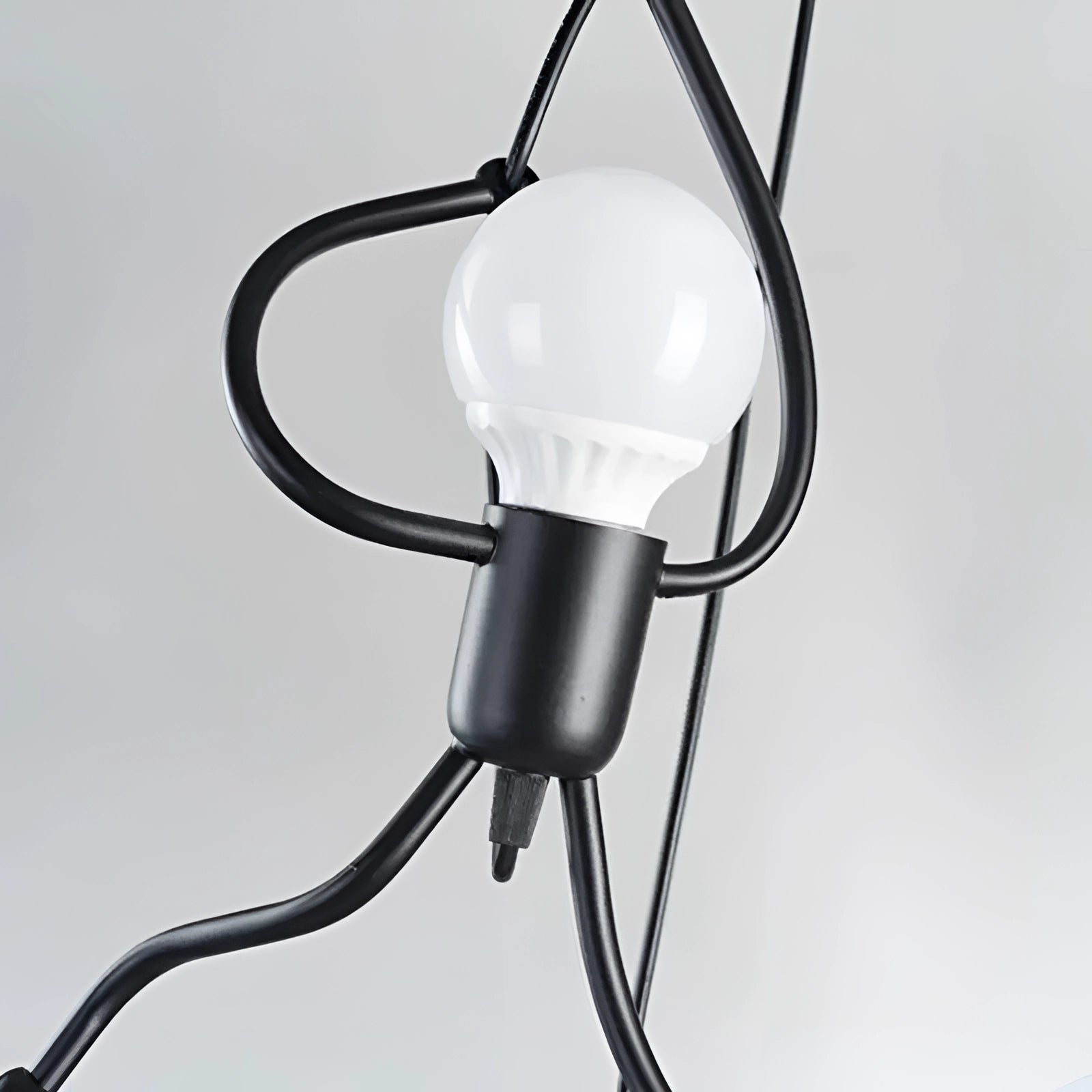 Modern minimalist pendant light with unique sculptural design, featuring sleek lines and a contemporary aesthetic.