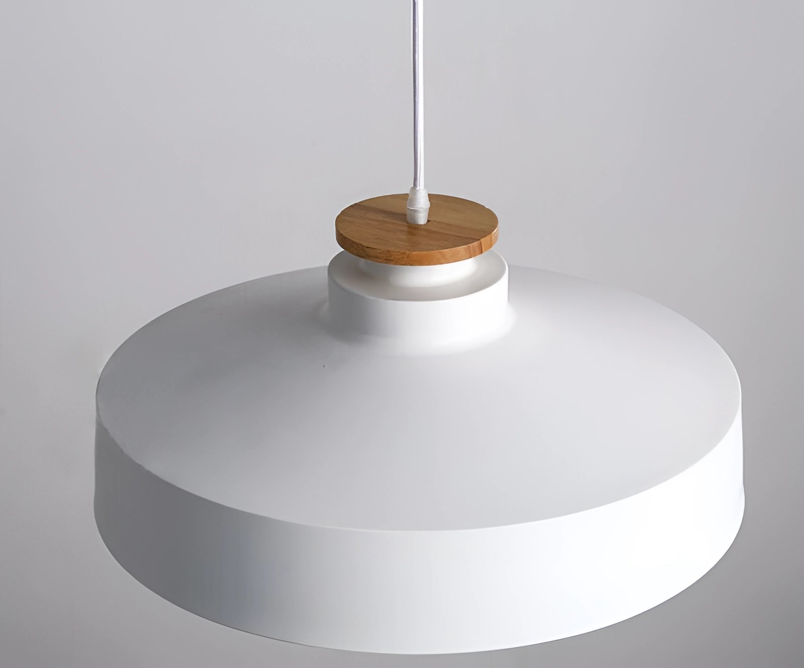 Modern minimalist black and white Scandinavian design pendant lights hanging from the ceiling with circular metal fixtures.