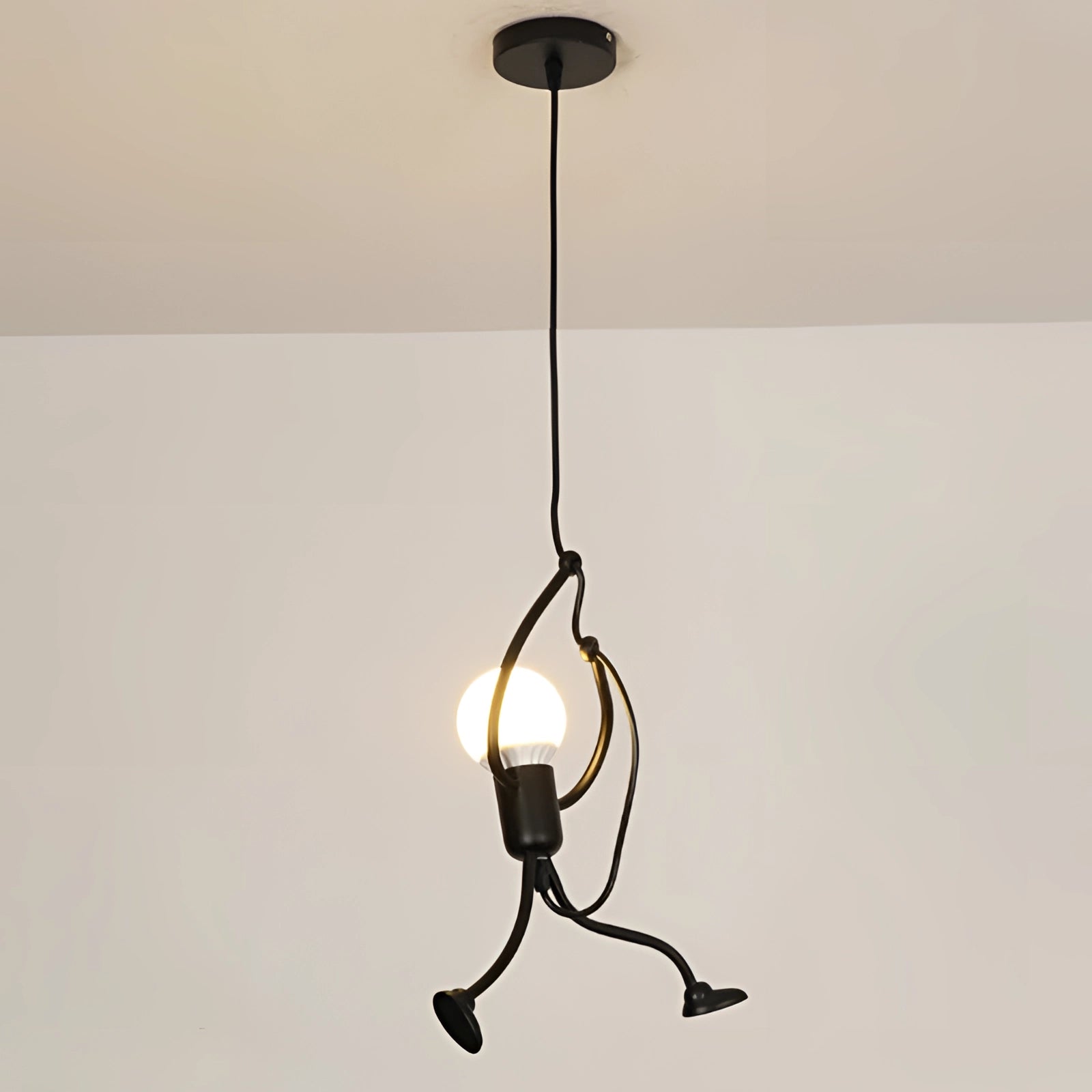 Modern Minimalist Pendant Light with a unique sculptural design, featuring a single lamp resembling a delicate twig or branch, combining elements of art and natural forms in shades of wood and metallic tones.