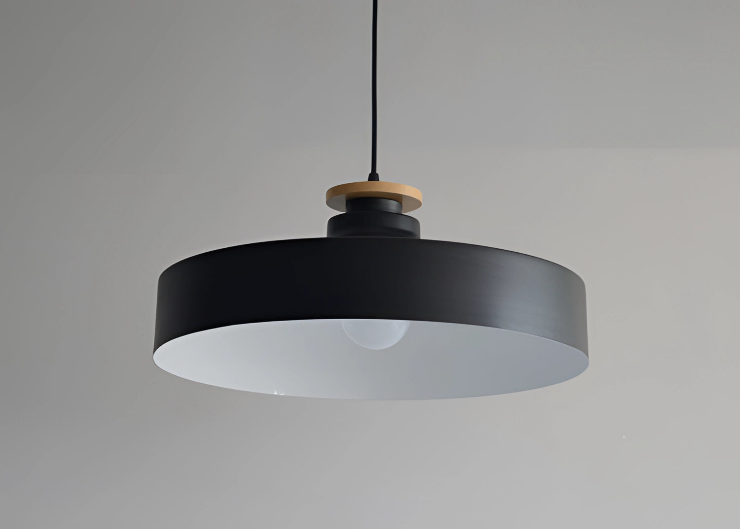 Modern minimalist black and white Scandinavian pendant lights with metal fixtures and circular lampshades.