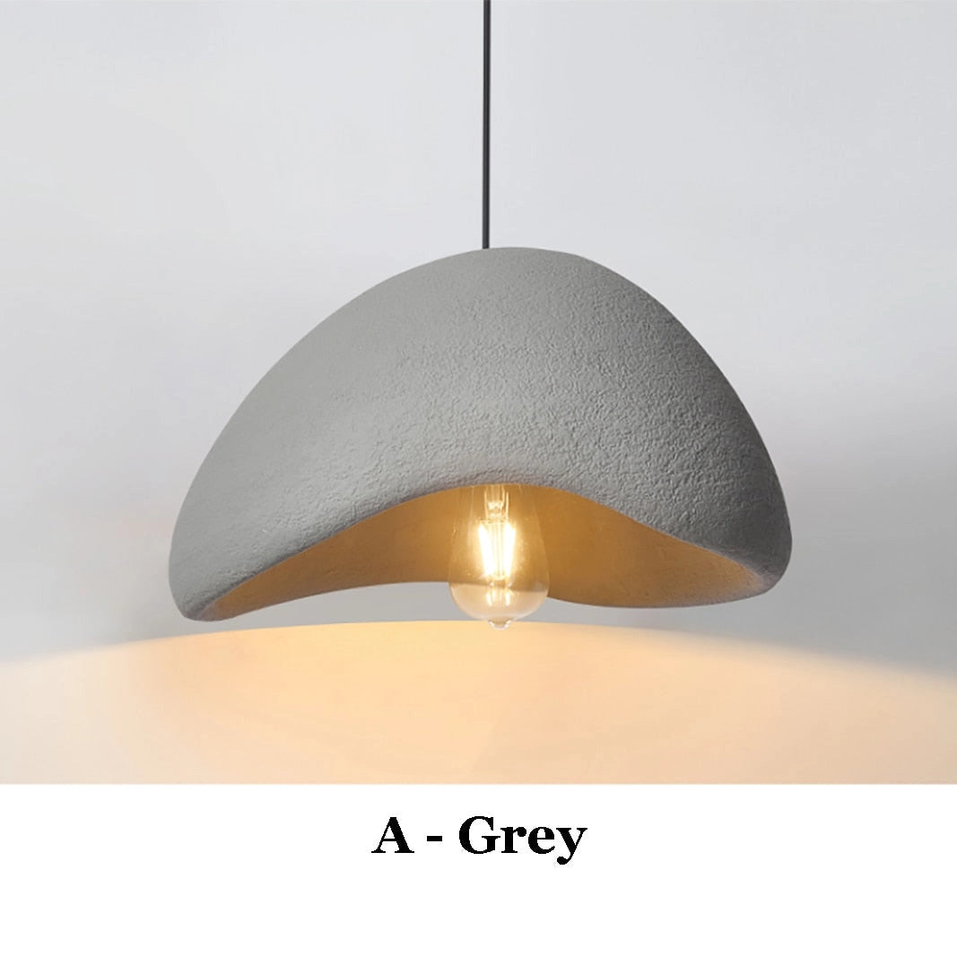 Modern minimalist pendant light with a gray circular shade, hanging from a ceiling fixture, featuring warm white illumination in a Scandinavian design.