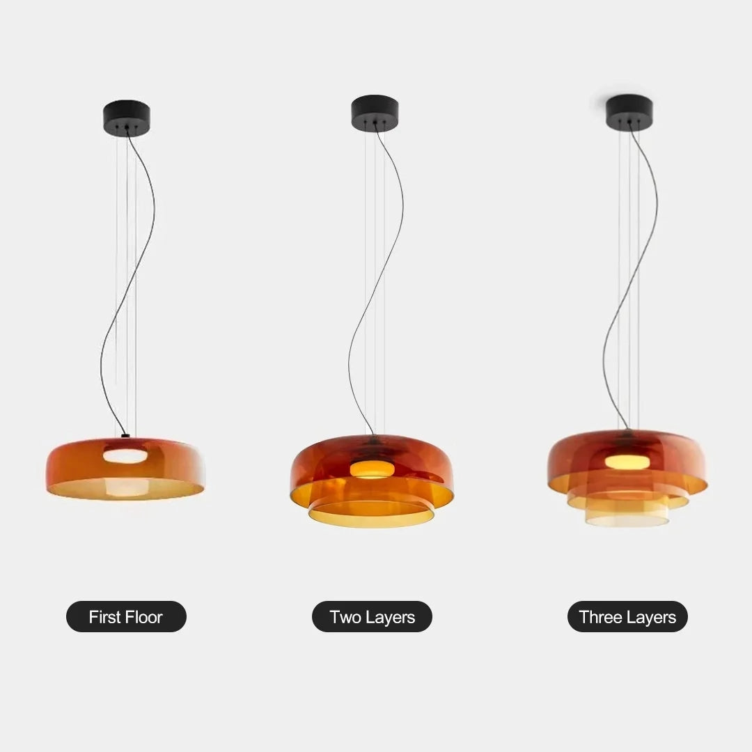 Modern multi-colored glass pendant light with a contemporary design, featuring vibrant amber tones and sleek, artistic elements.