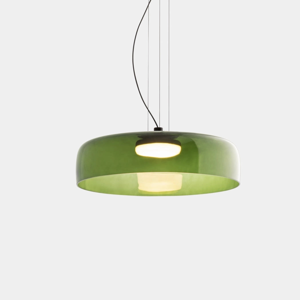 A modern multi-colored glass pendant light with a green lampshade, featuring a circular design and contemporary metal accents, suspended from the ceiling.