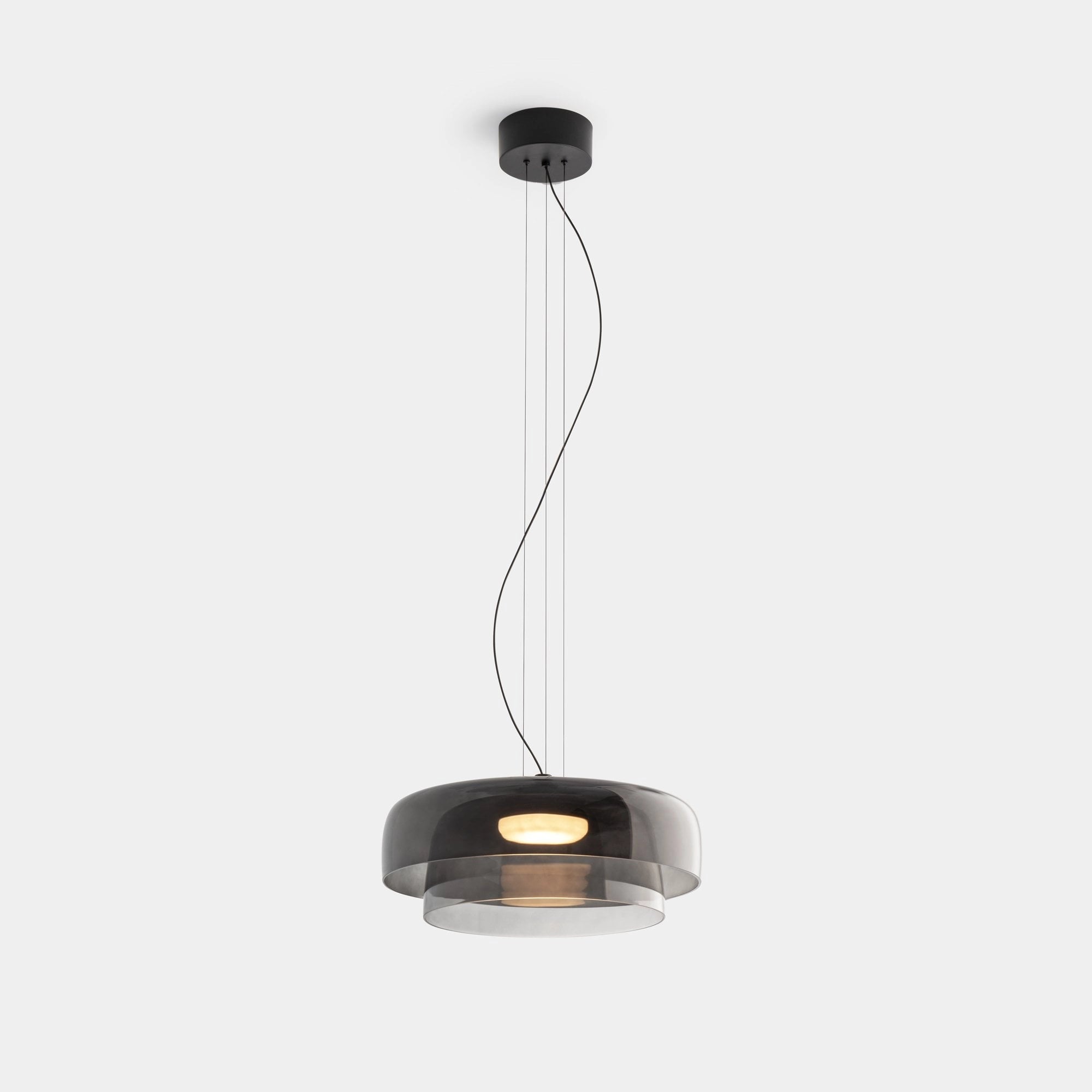 Modern multi-colored glass pendant light with contemporary design, suspended as a ceiling fixture, featuring sleek metal elements.