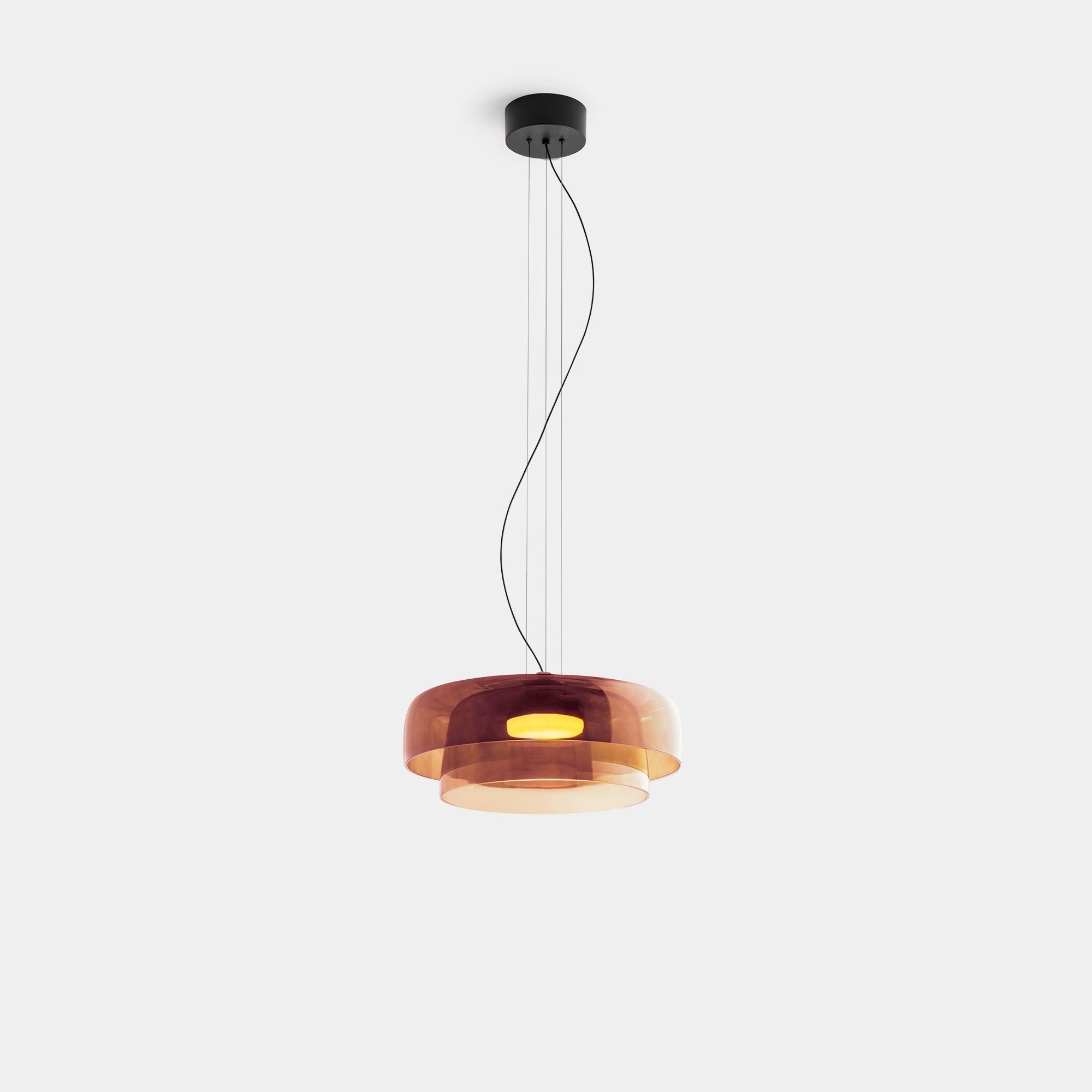 Modern multi-colored glass pendant light with a contemporary design, featuring a sleek rectangular shape and copper accents, hanging from the ceiling.