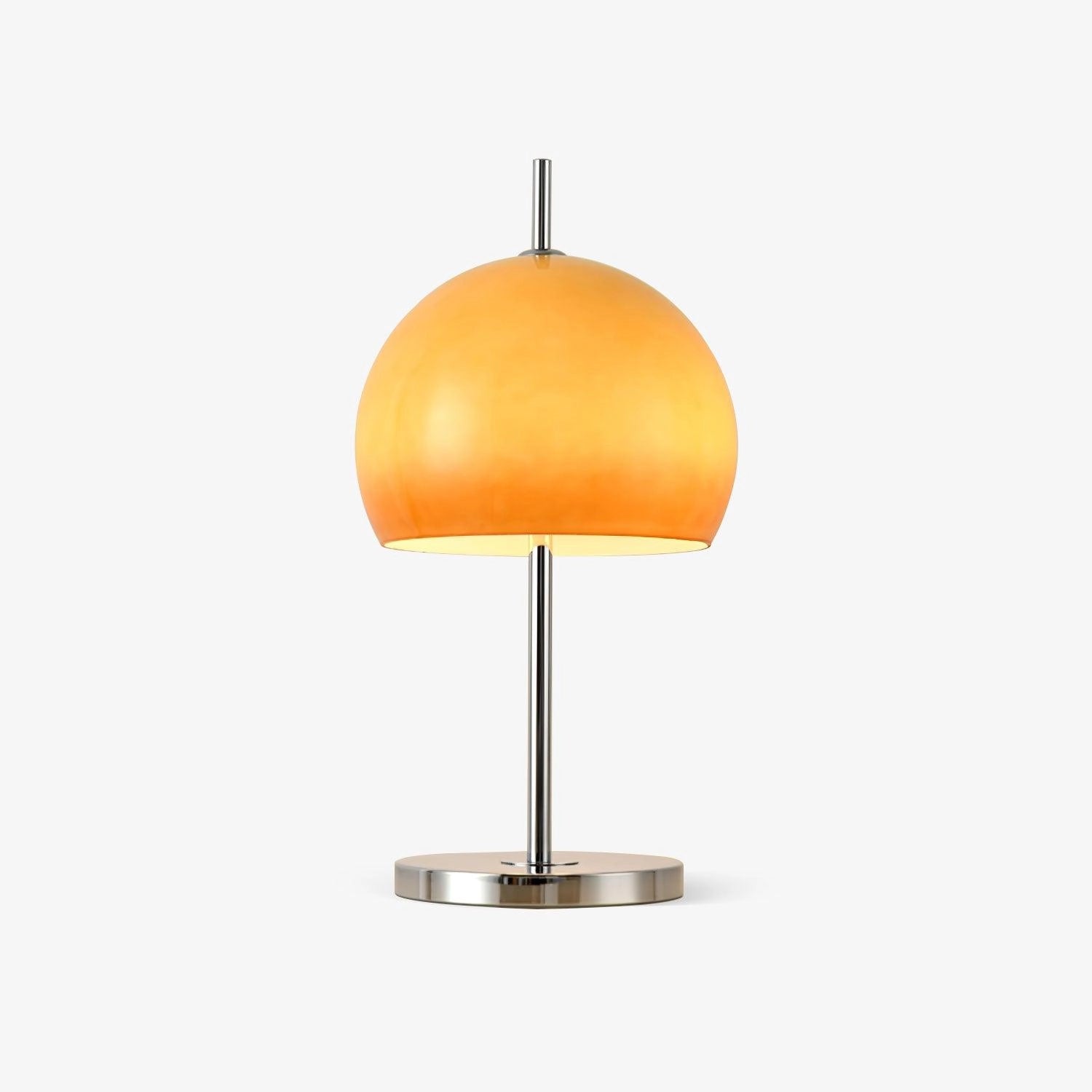 Modern orange globe table lamp with chrome base, emitting warm light, placed on a wooden surface next to a small green plant.
