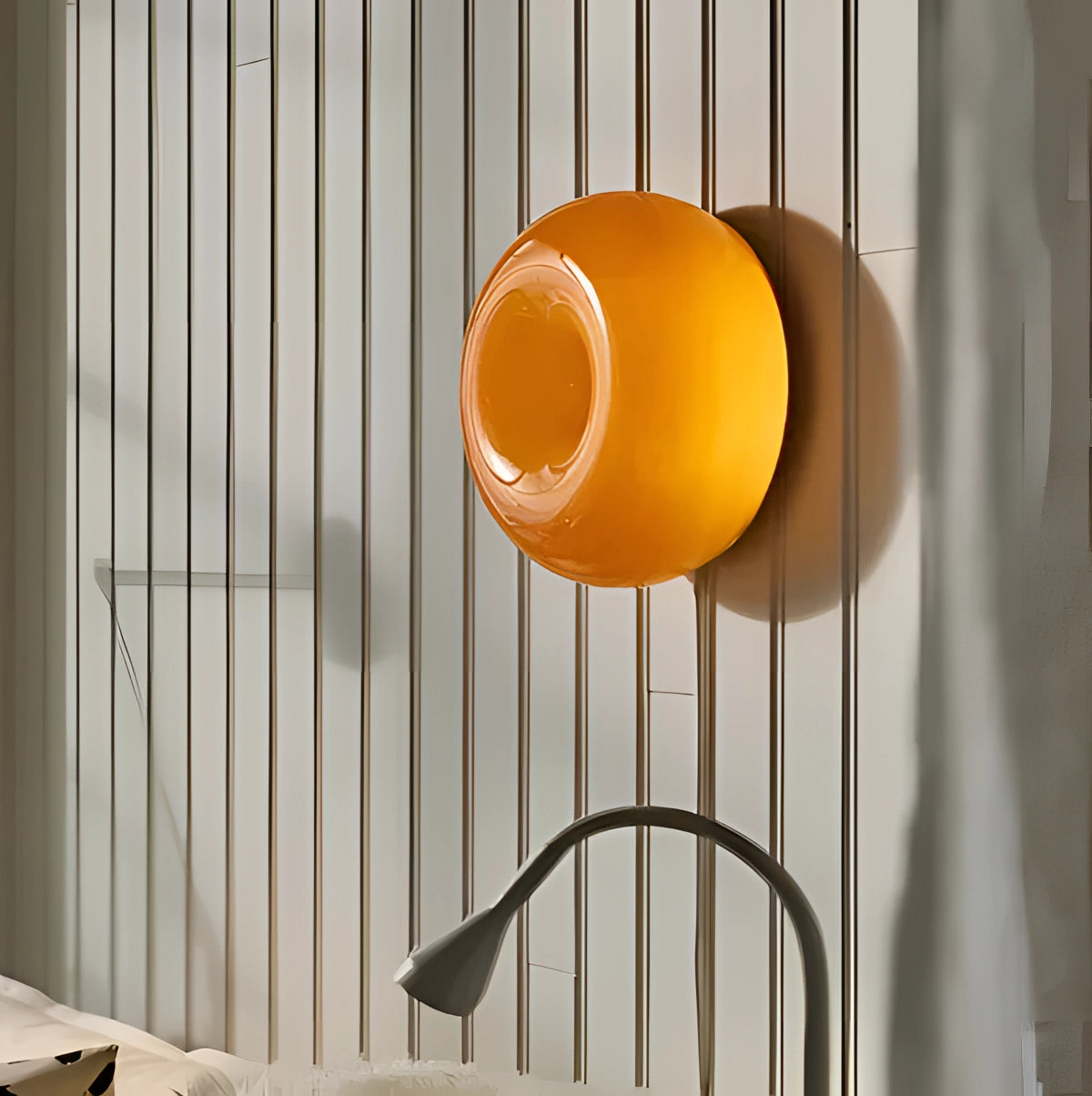 Circular contemporary wall light with a modern design, featuring an orange tint and integrated with wood and metal materials, suitable for interior settings.