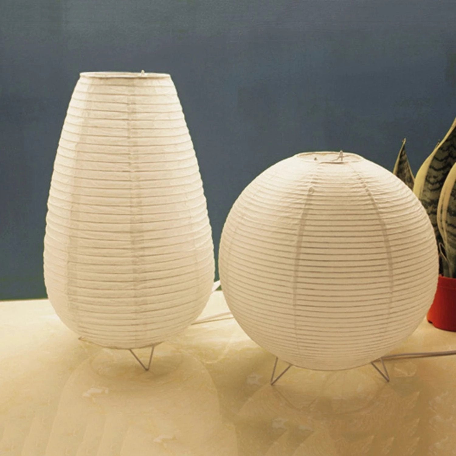 Oval paper floor lamp with a modern design featuring energy-efficient LED lighting, displayed with wooden accents and a symmetrical oval shape.