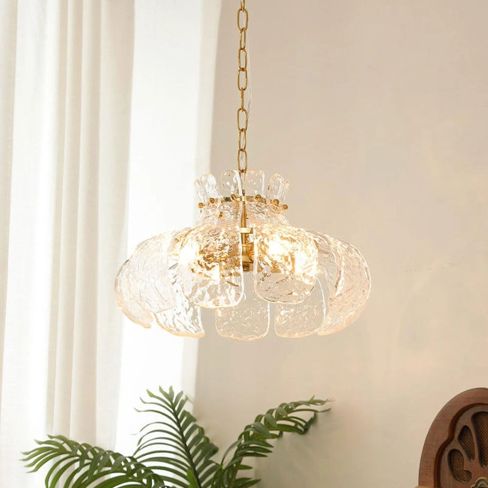 Modern pear-shaped glass chandelier with a luxurious gold chain, featuring intricate design elements resembling natural twigs and ornaments, highlighting a sophisticated blend of gold and earthy tones.