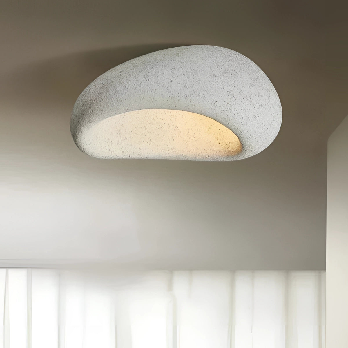 Modern pebble ceiling lamp in cement white with a 52cm oval shape, featuring a sleek design that combines elements of wood and metal for luxurious ambient lighting.