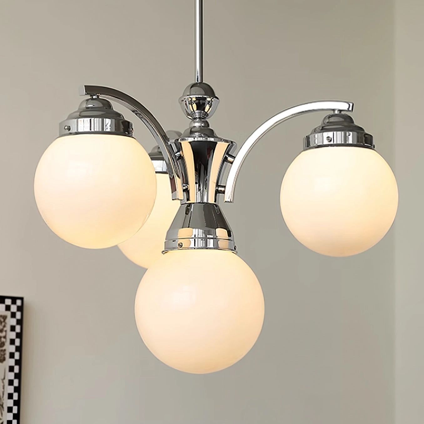 Modern pink glass chandelier with elegant minimalist design, featuring a circular ceiling fixture and light bulbs.