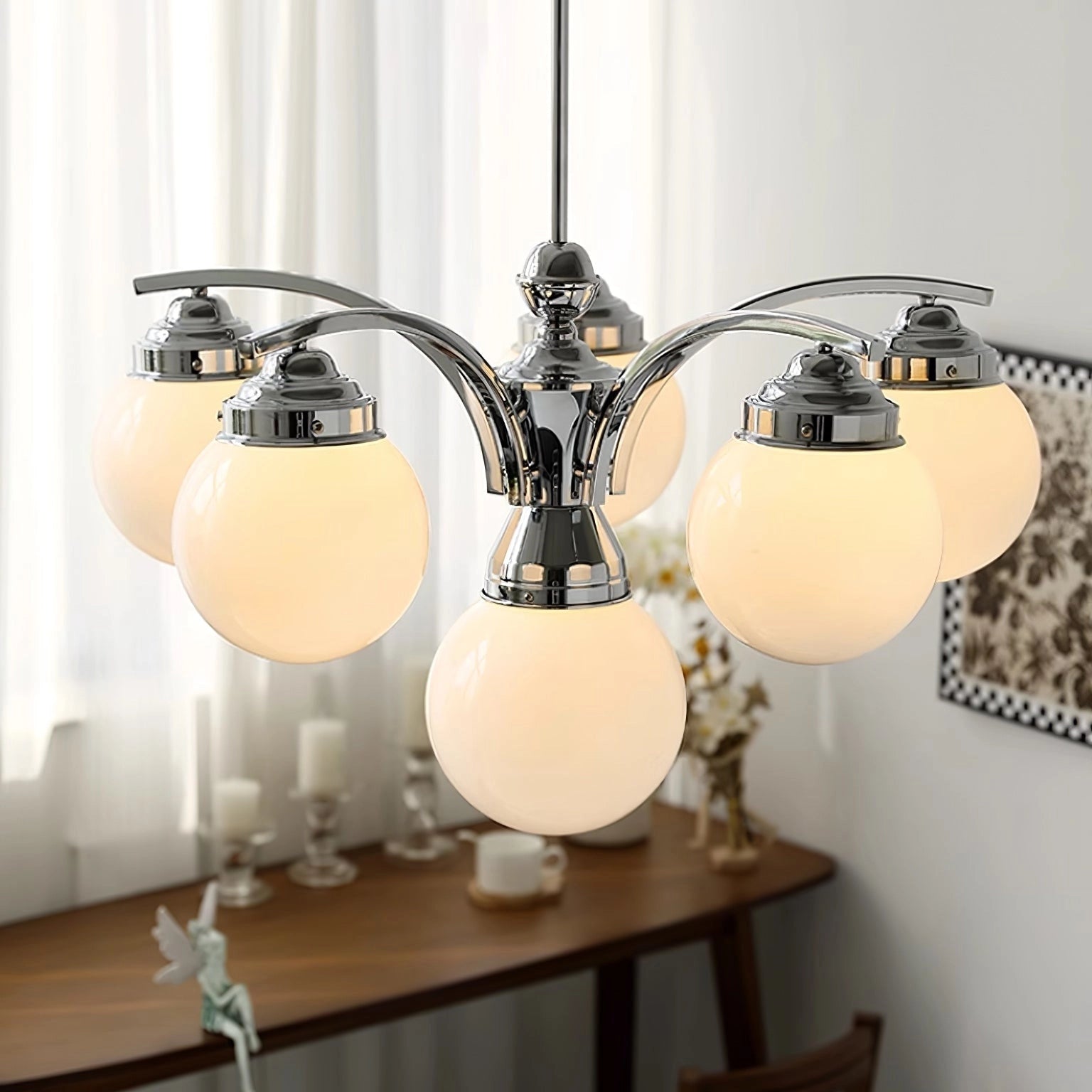 Elegant minimalist ceiling light featuring a modern pink glass chandelier with chrom and beige finish, six lamps, and a diameter of 75cm by 45cm height, illuminating a stylishly designed room with wooden furniture and artistic elements.
