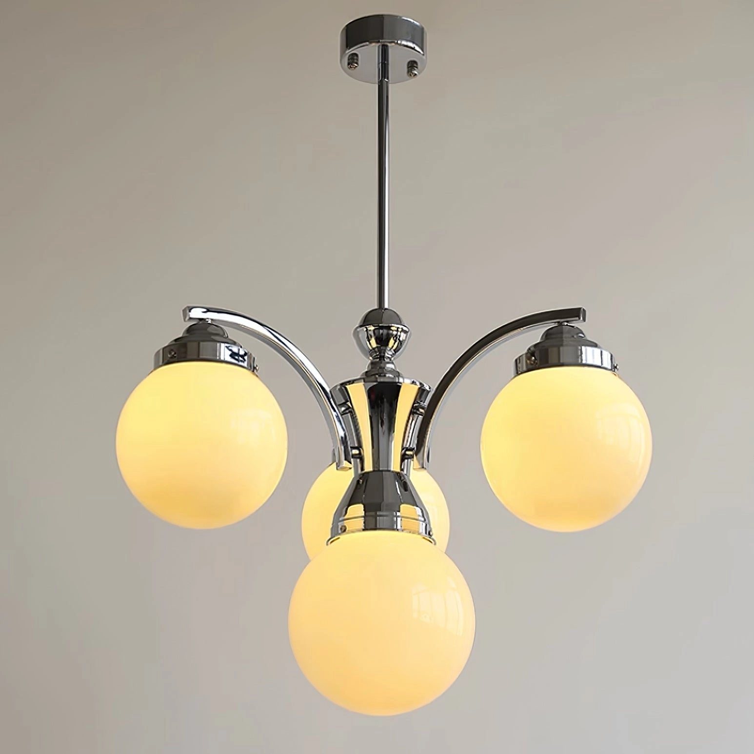 Modern pink glass chandelier with elegant minimalist design, featuring amber tints, circular light bulbs, and ceiling-mounted installation.