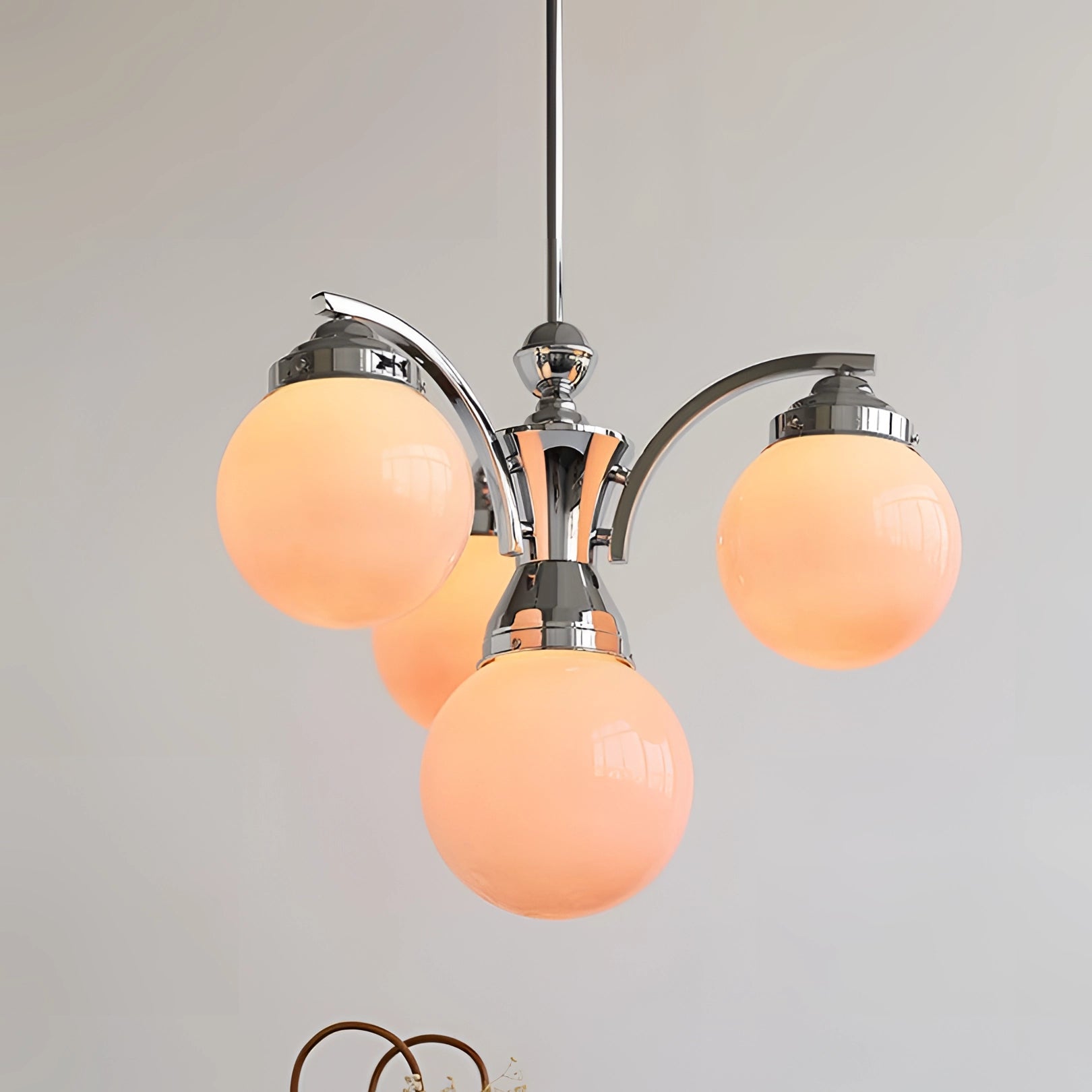 Elegant minimalist pink glass chandelier with circular amber-tinted shades, ceiling-mounted.