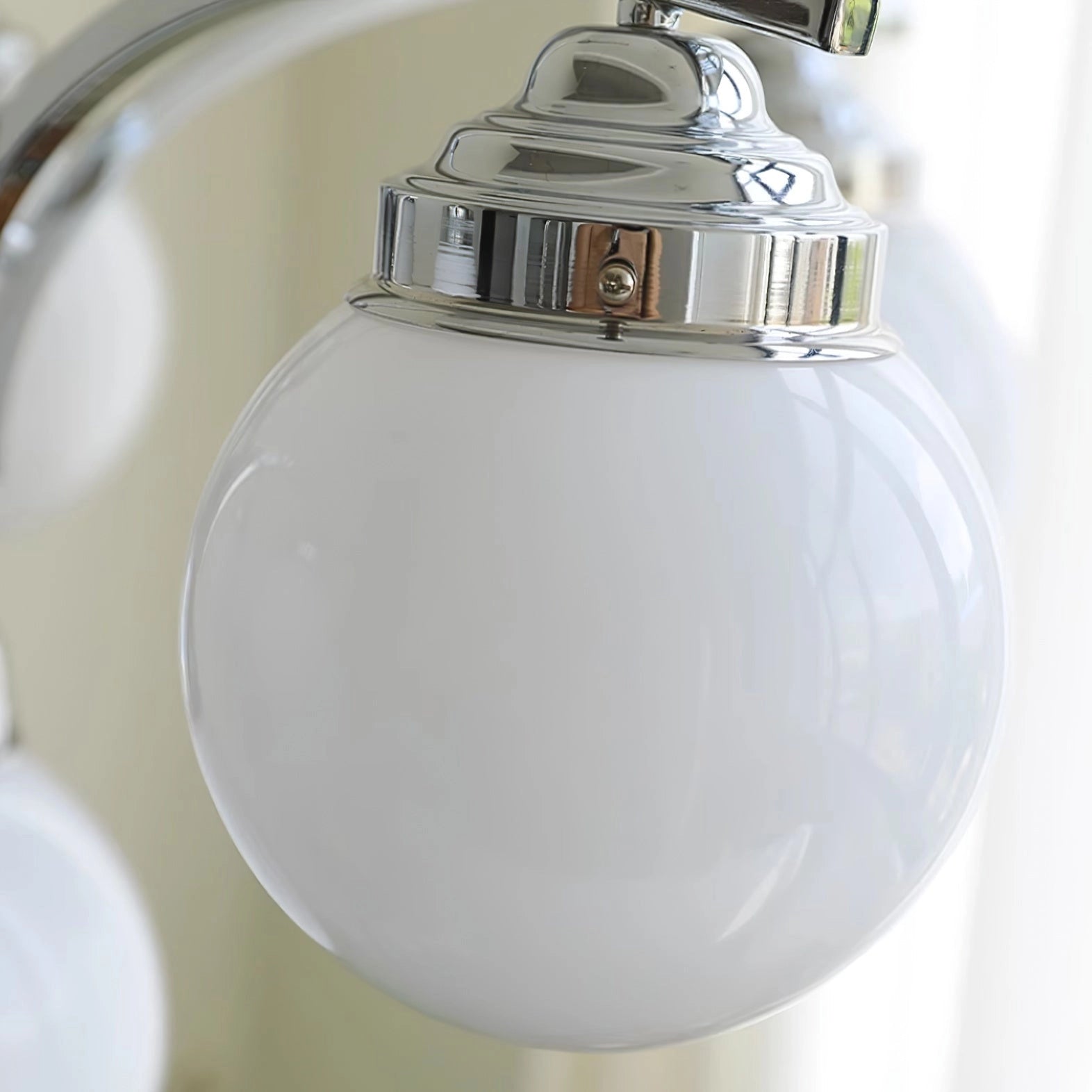 Elegant minimalist ceiling light with modern pink glass chandelier design, featuring an oval shape and nickel finish.