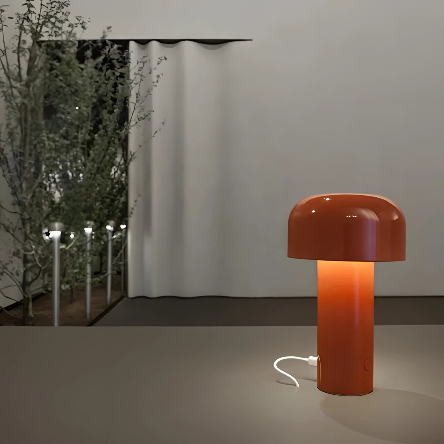 Modern portable wireless LED lamp with a sleek design and touch control, situated in a stylish interior setting featuring wooden and composite material elements, enhancing the ambiance of the room.
