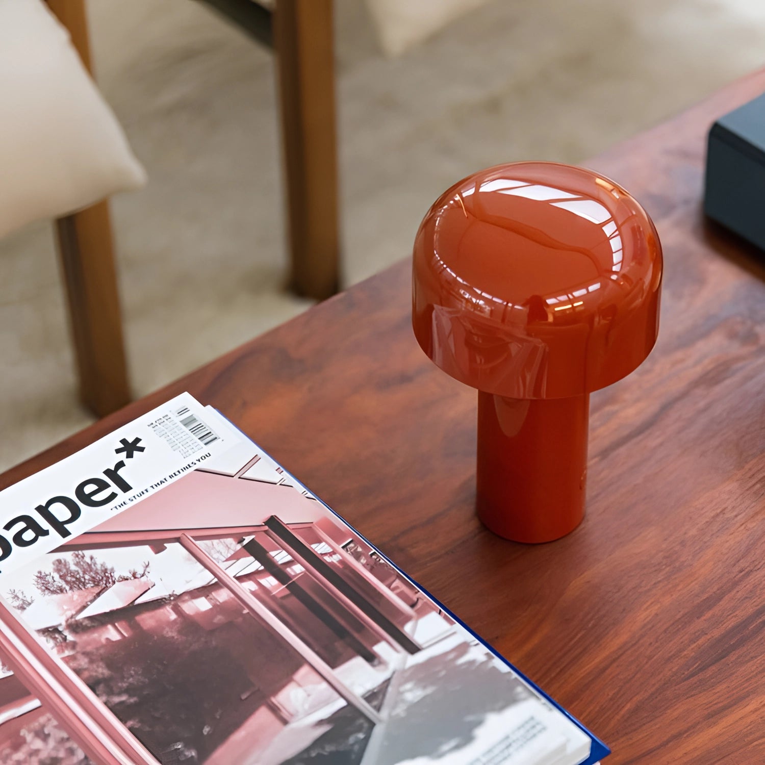 Modern portable wireless LED lamp with a sleek design and touch control, placed on a wooden table with a hardwood finish.