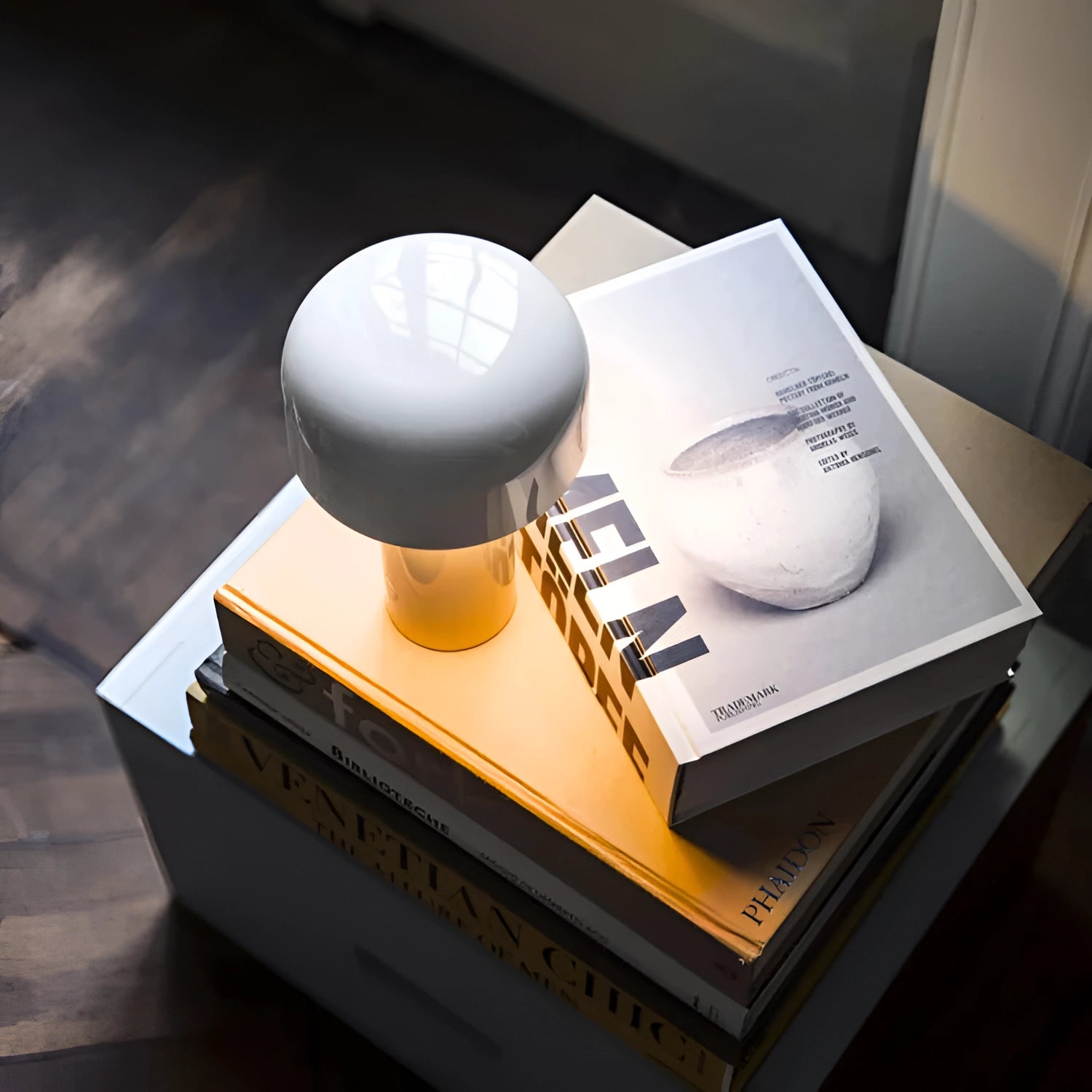 Modern portable wireless LED lamp with a sleek design and touch control, featuring a smooth, minimalist structure suitable for office use.