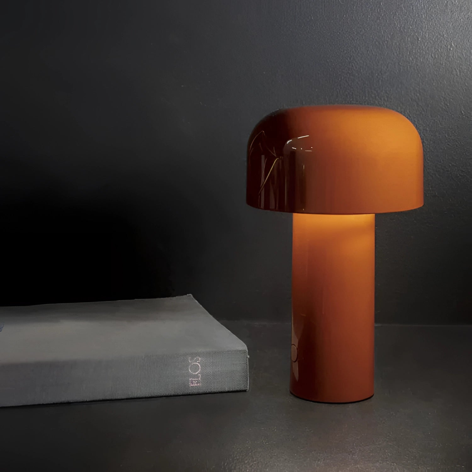 Modern portable wireless LED lamp with a sleek rectangular design featuring touch control, positioned on a wooden table. The lamp includes a lampshade and emits a soft, warm glow, perfect for ambient lighting.