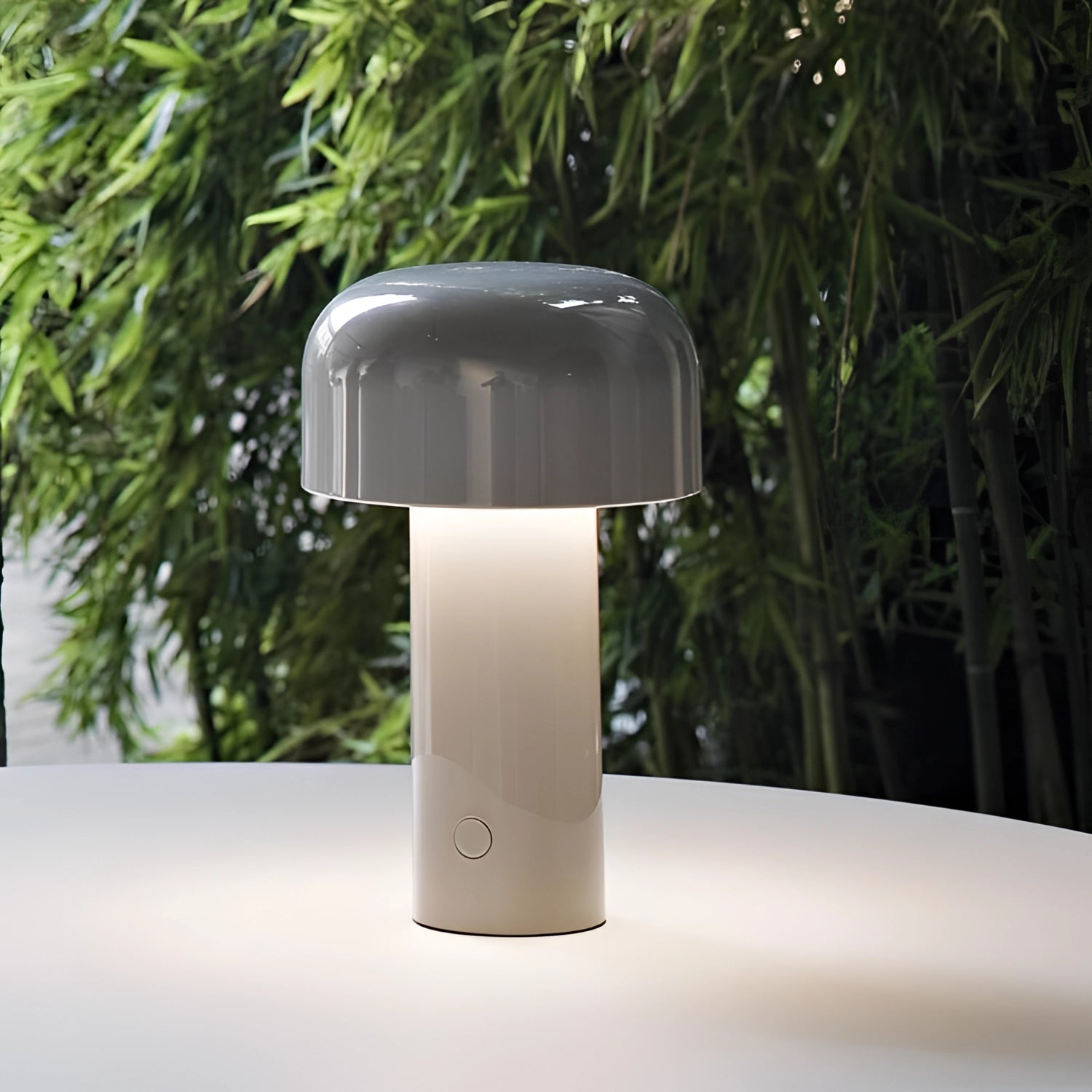 Modern portable wireless LED lamp with a sleek design and touch control feature, placed on a wooden tabletop next to a potted plant.