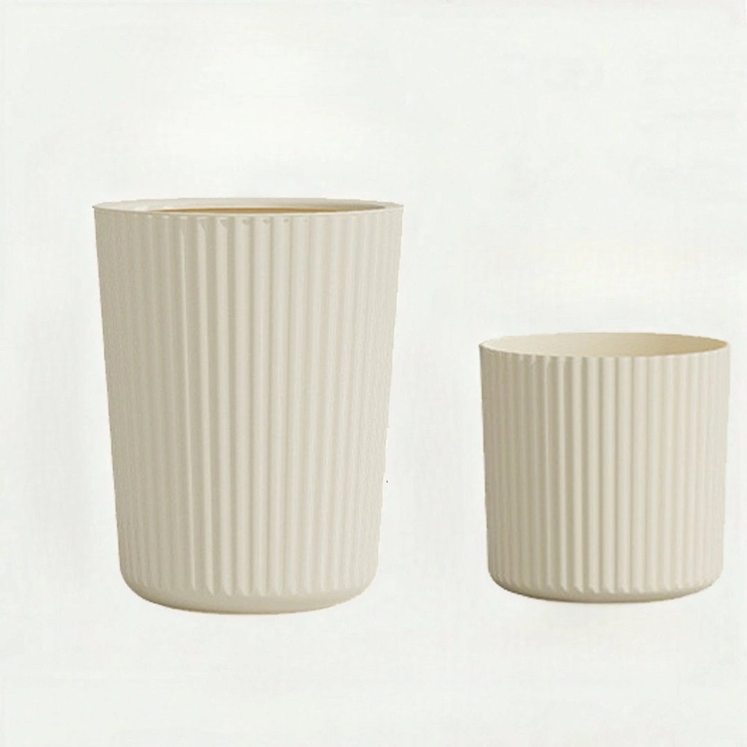 Beige large modern ribbed ceramic planter in a Scandinavian design, showcasing a cylindrical shape on a wooden surface.