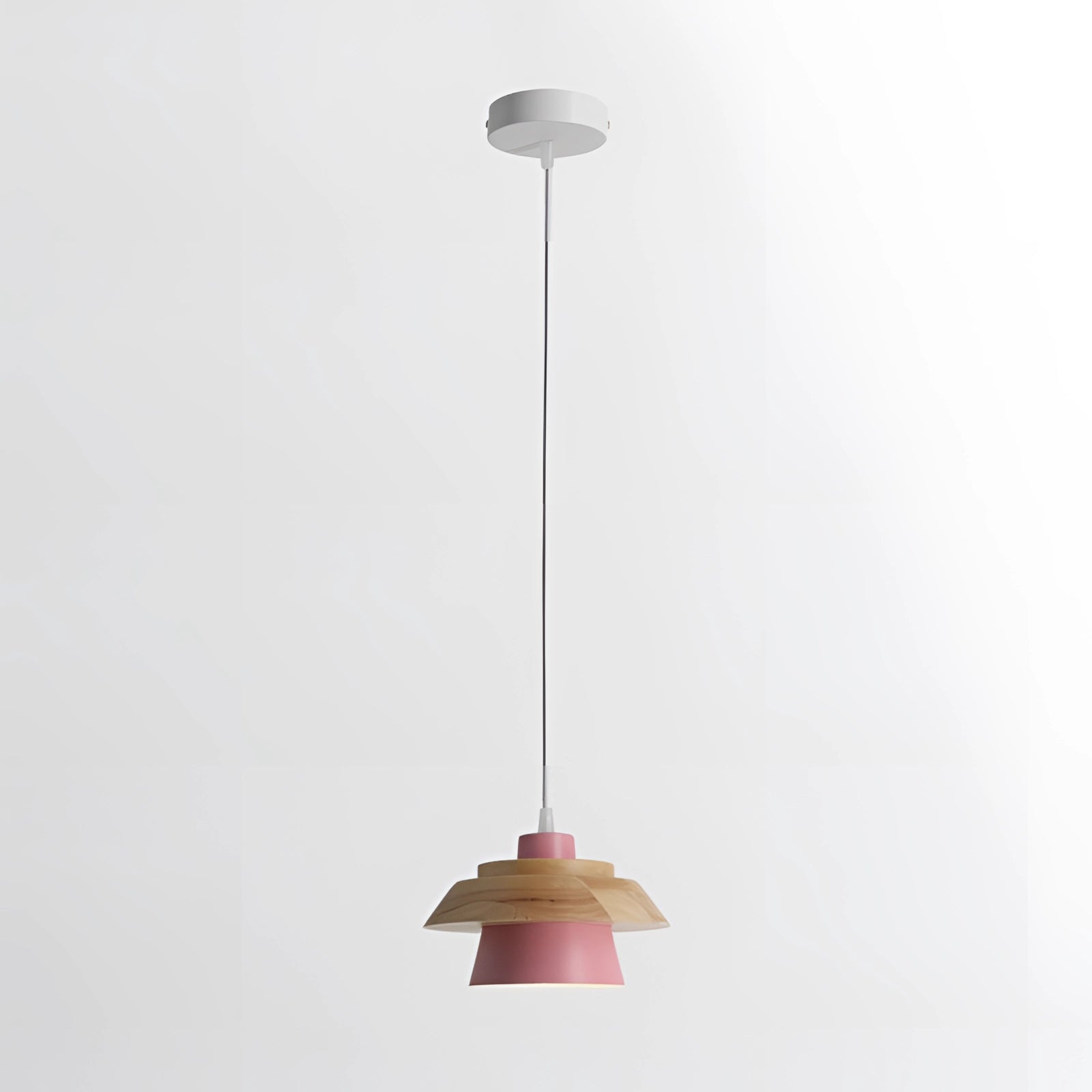 Modern Scandinavian black pendant lamp with a pink wood accent hanging from a ceiling, featuring a circular lampshade and designed for kitchen use.