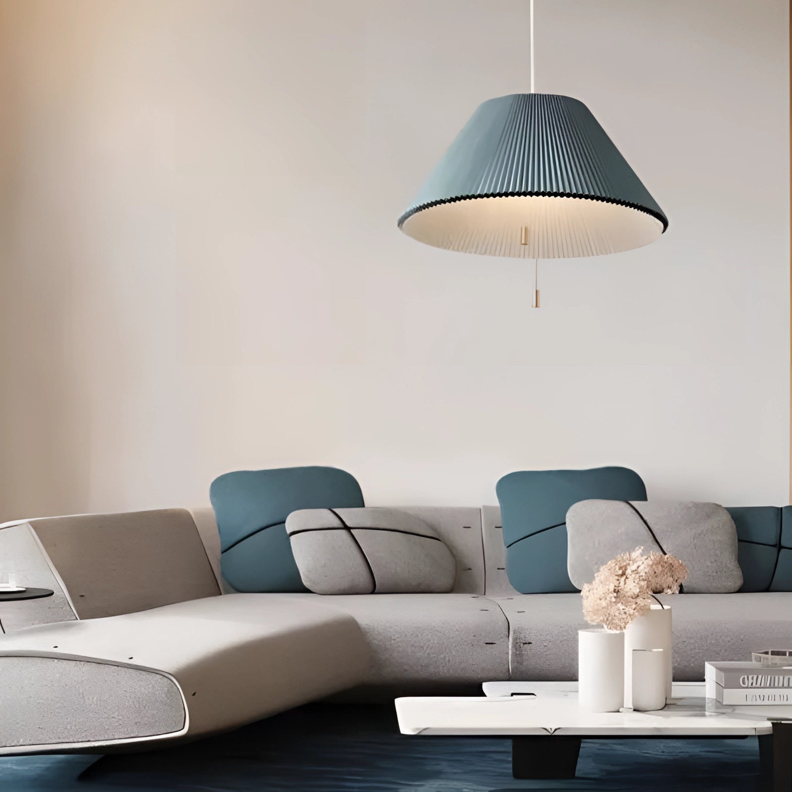 Modern Scandinavian blue pendant lights hanging from the ceiling, illuminating a stylish interior space with a white and comfortable ambiance, complementing the contemporary furniture and design elements.