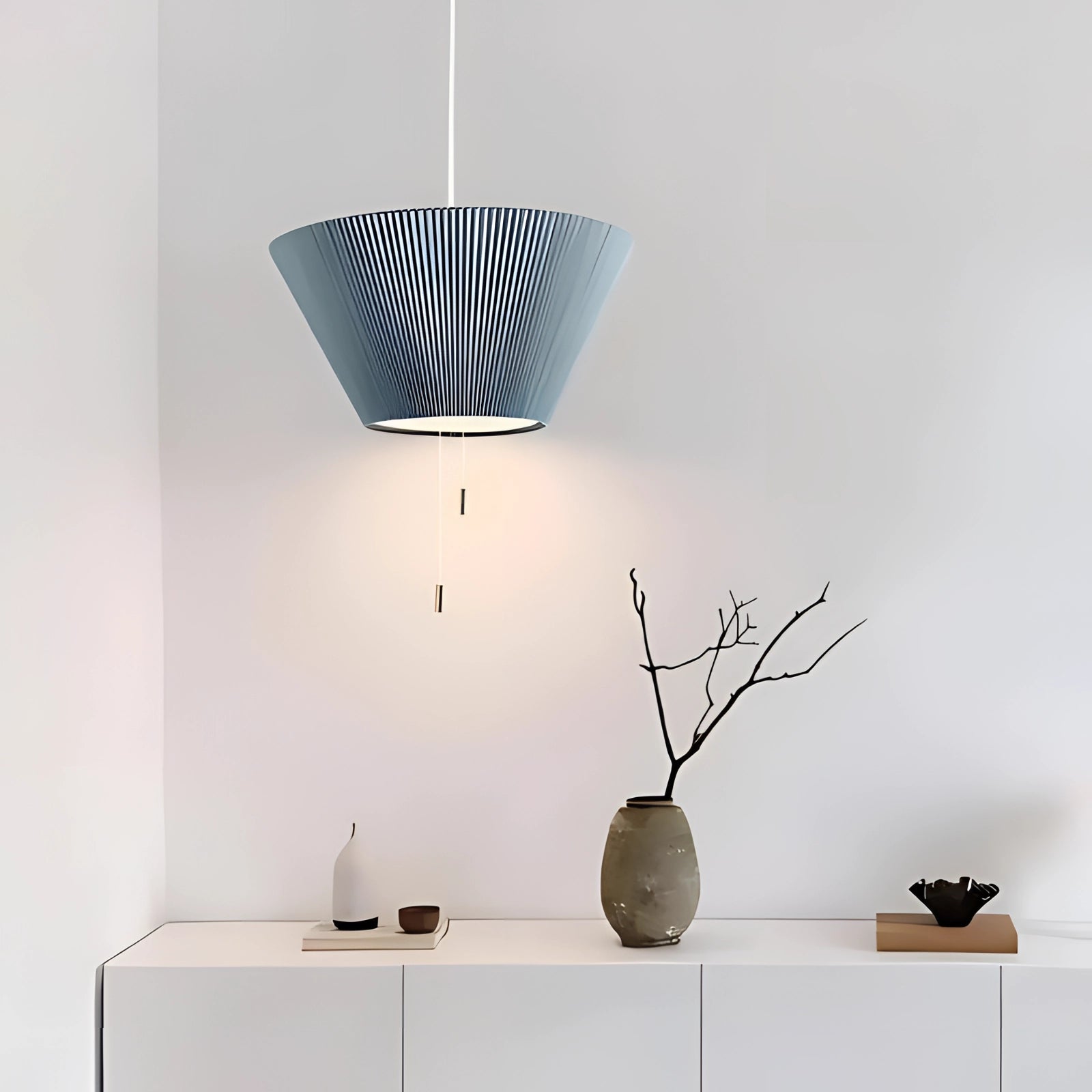 Modern Scandinavian blue pendant lights hanging over a kitchen table, featuring a sleek and minimalist design.
