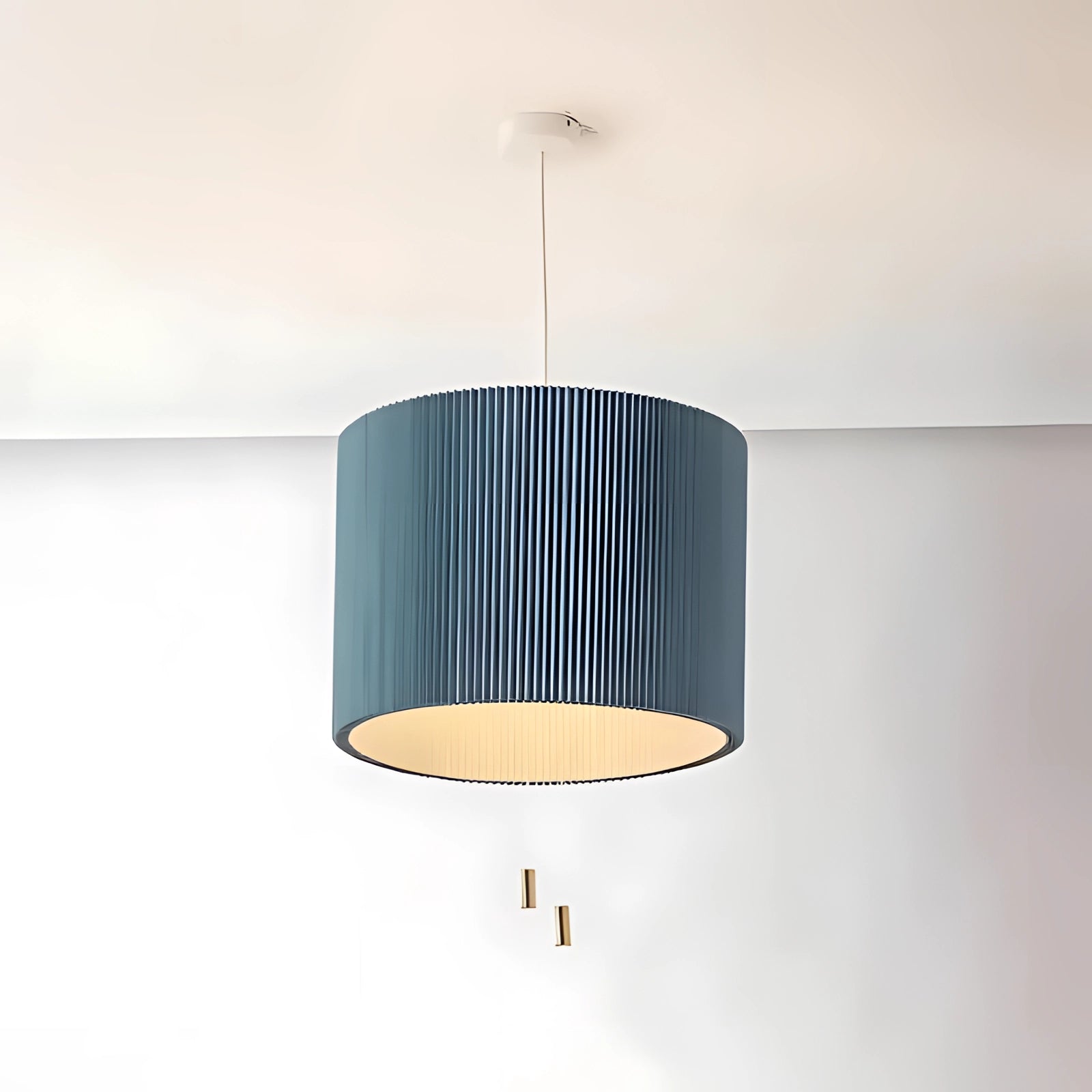 Blue Scandinavian-style pendant light with a wooden accent, featuring a cylindrical lampshade, suspended from the ceiling.