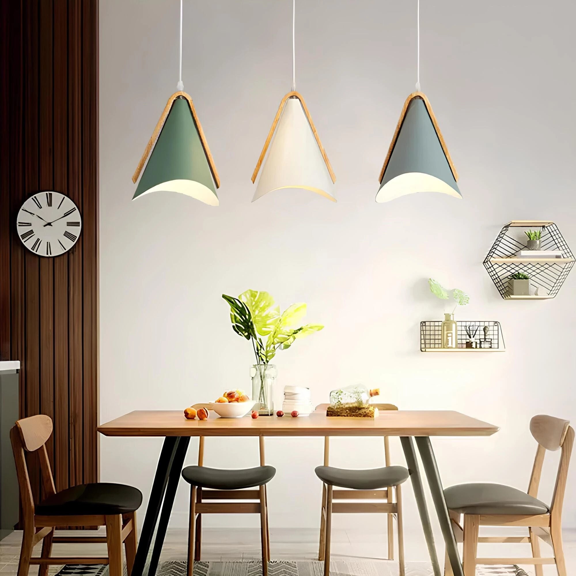 Modern Scandinavian cone pendant lights with wood accents hanging above a minimalist kitchen and dining setup, featuring a white table, orange chairs, and green plants, illustrating a sleek interior design.