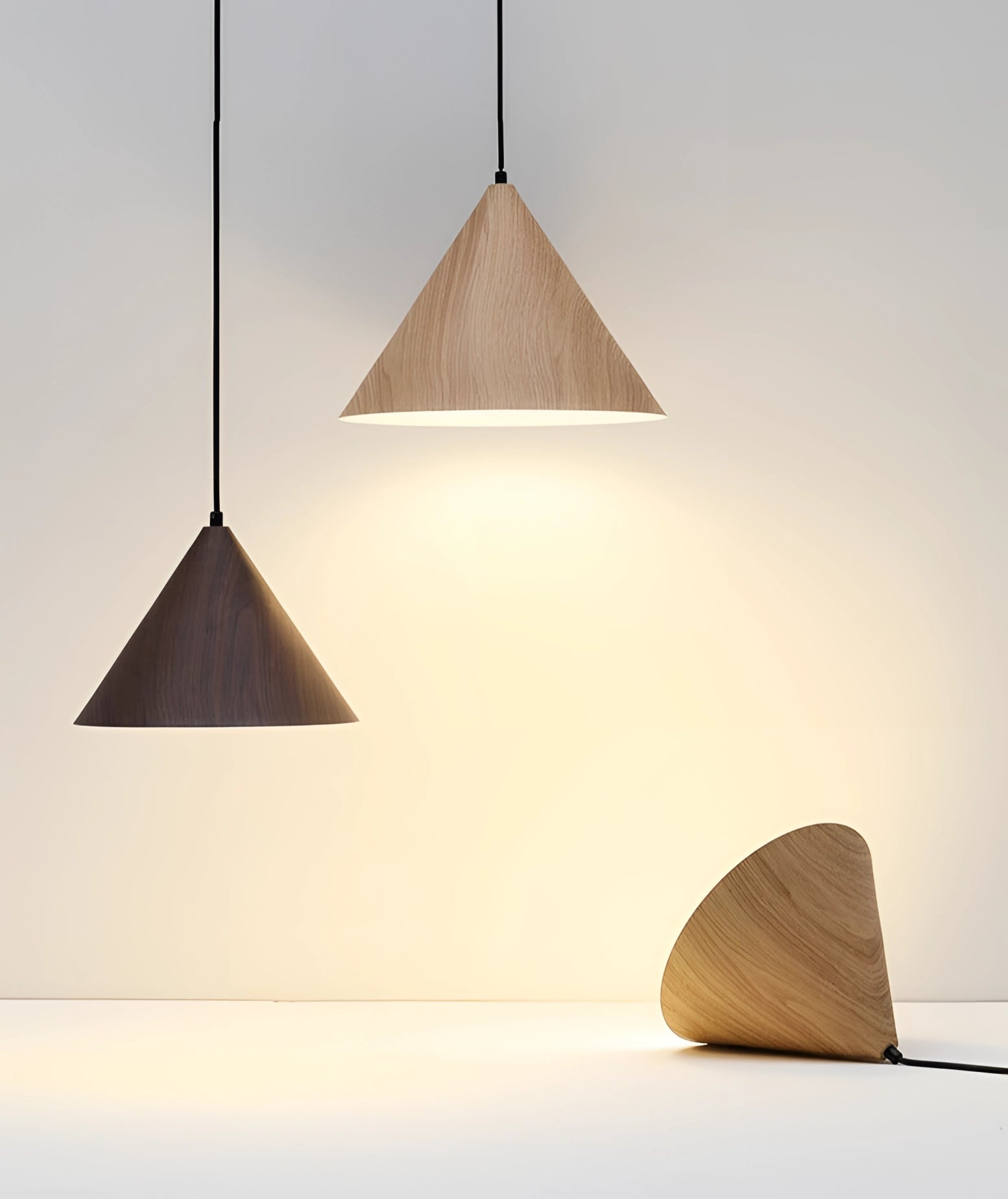 Modern Scandinavian eco-friendly pendant light featuring a triangle wooden design with a sleek, minimalist lampshade hanging from the ceiling.