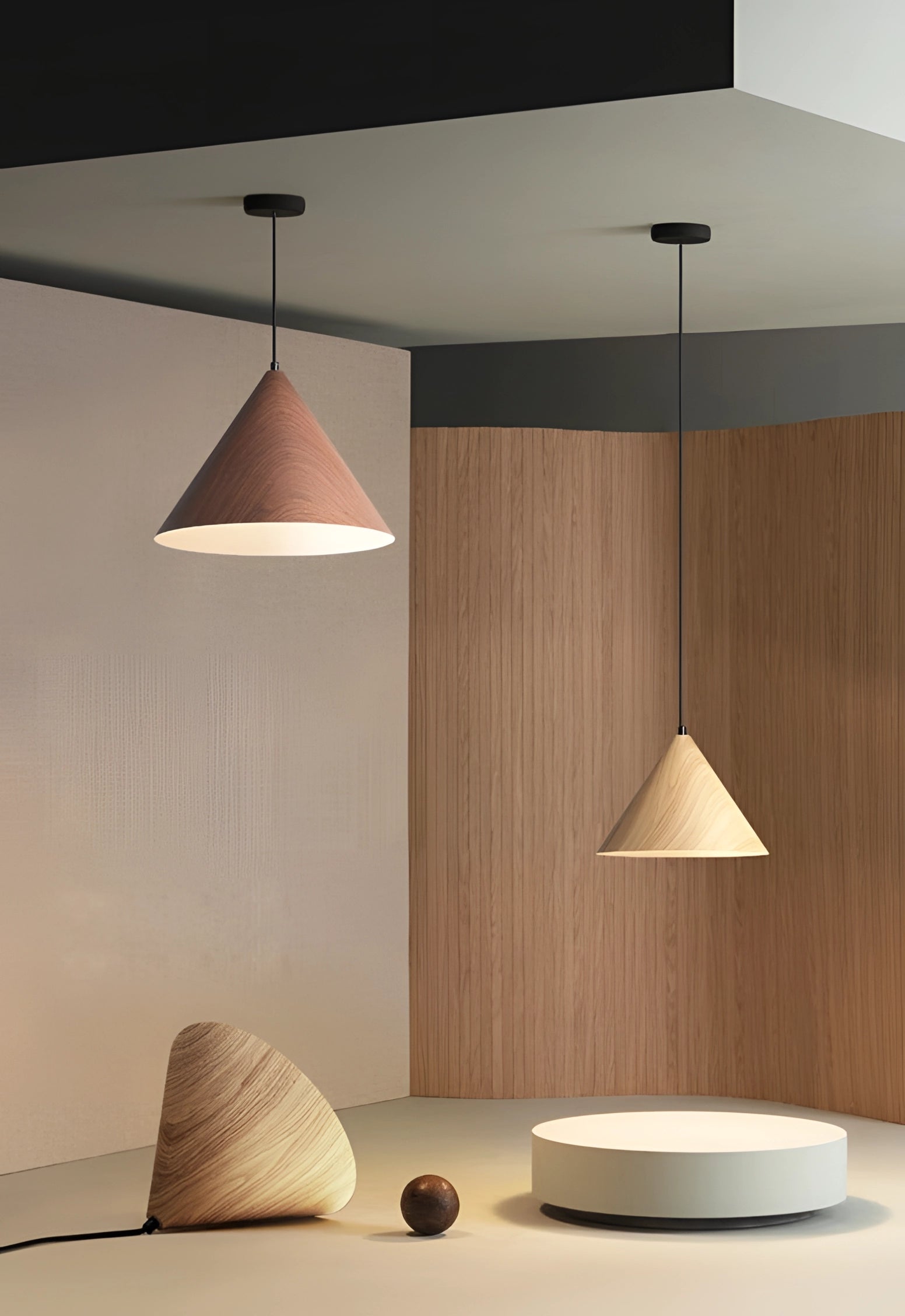 Modern Scandinavian eco-friendly triangle wooden pendant light hanging from a ceiling, featuring a geometric design with a wooden shade and providing warm, ambient lighting in a stylish interior setting.