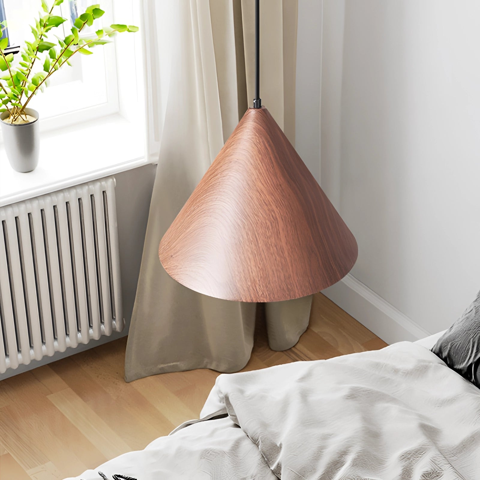 Modern Scandinavian eco-friendly triangle wooden pendant light hanging above a table with a houseplant and flowerpot, highlighting the natural wood finish and minimalist design that complements the cozy and sustainable interior decor.