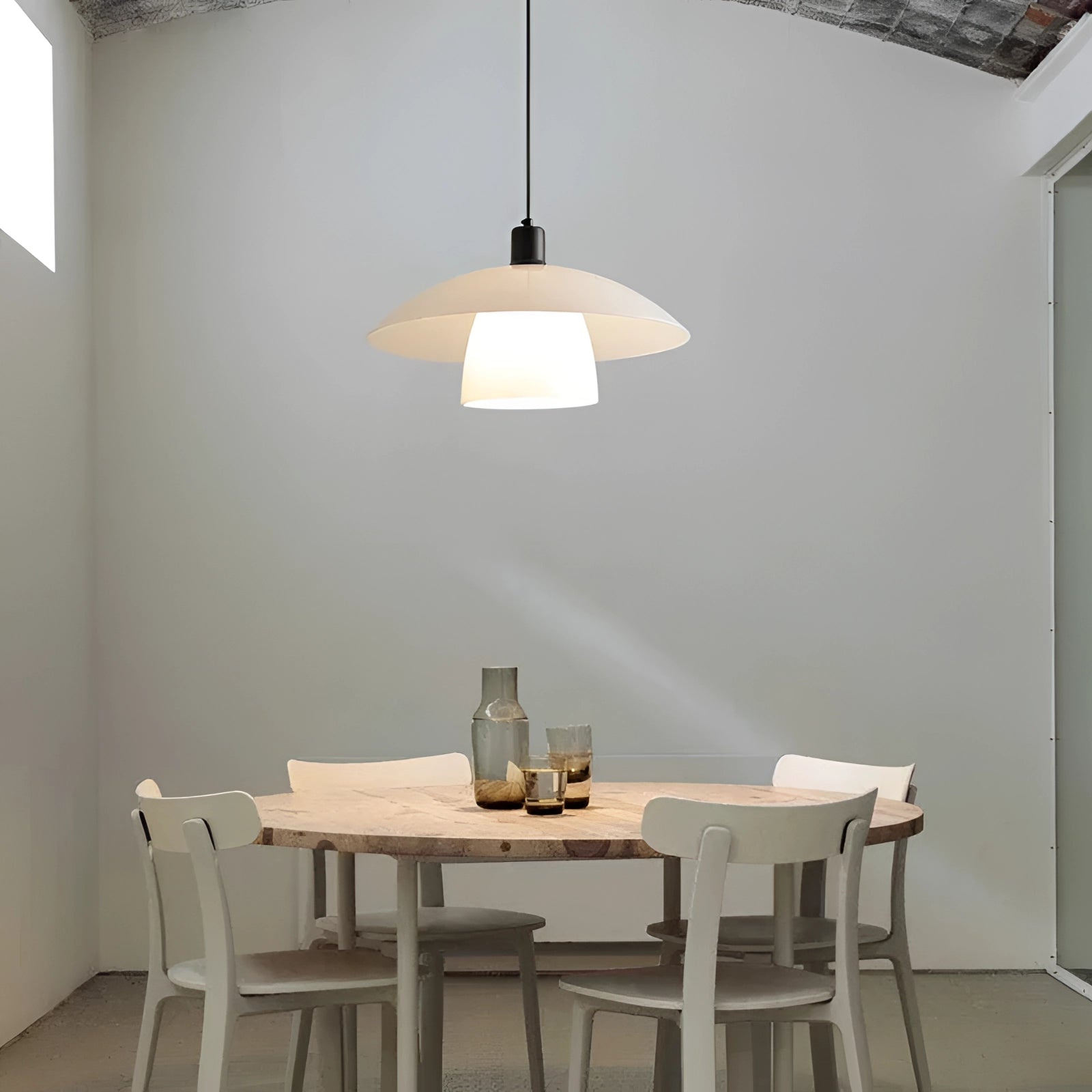 Modern Scandinavian white dome pendant lights above a kitchen island, with wooden furniture and interior design elements including a table and chairs.