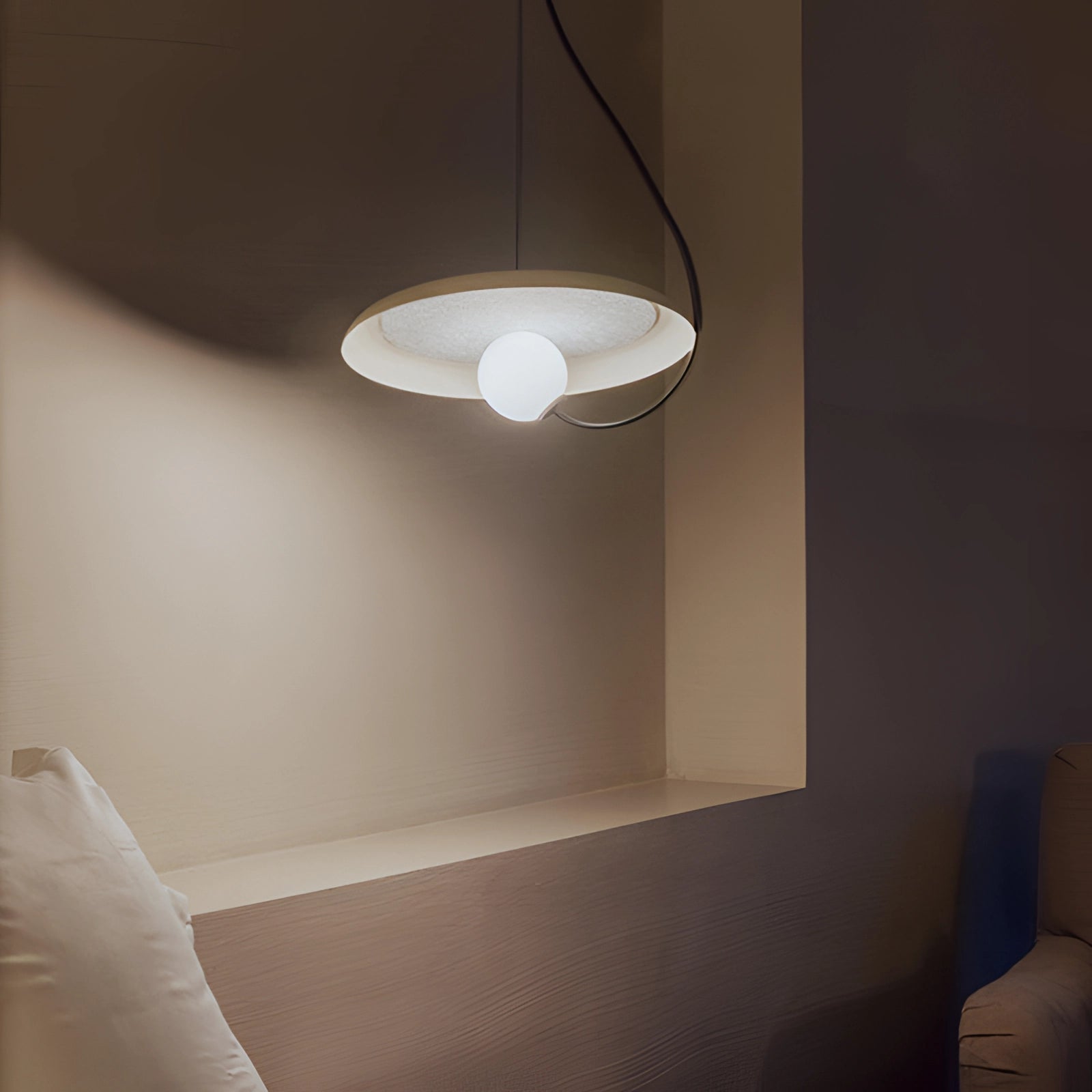 Modern Scandinavian pendant light with a minimalist design, featuring a wooden accent and a sleek shade, hanging from the ceiling in an elegantly designed interior space.