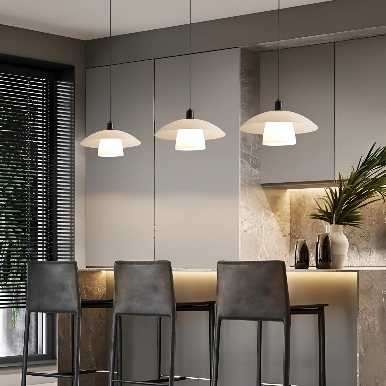 Modern Scandinavian white dome pendant lights hanging over kitchen island with wooden accents and contemporary interior design.
